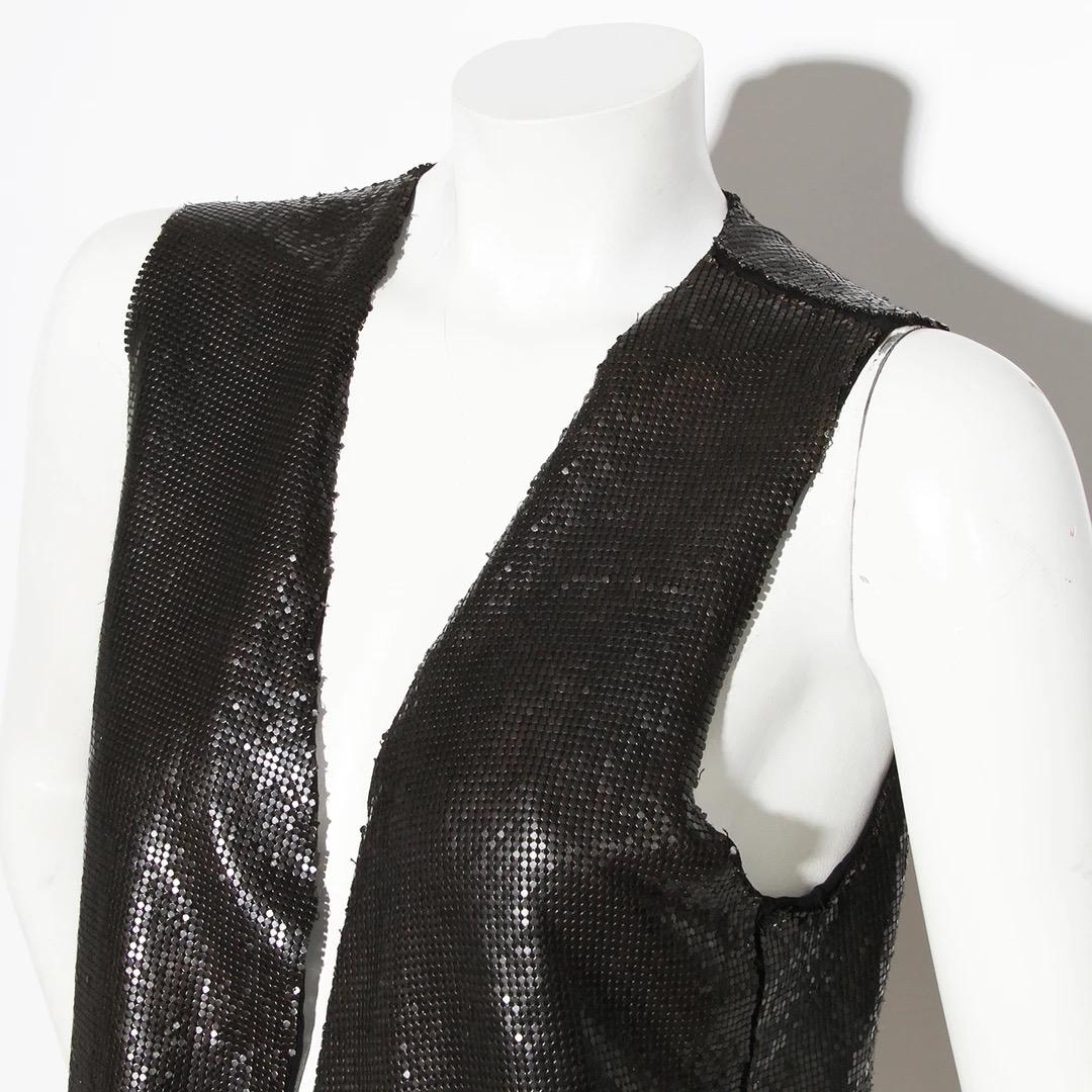 Ann Demeulemeester Chainmail Vest 
Made in India 
Black Chainmesh 
Asymmetrical hemline 
100% Brass 
Interior lined in 100% black silk 
Excellent condition; Preloved with no visible signs of wear or use throughout vest. 
 Size/Measurements: