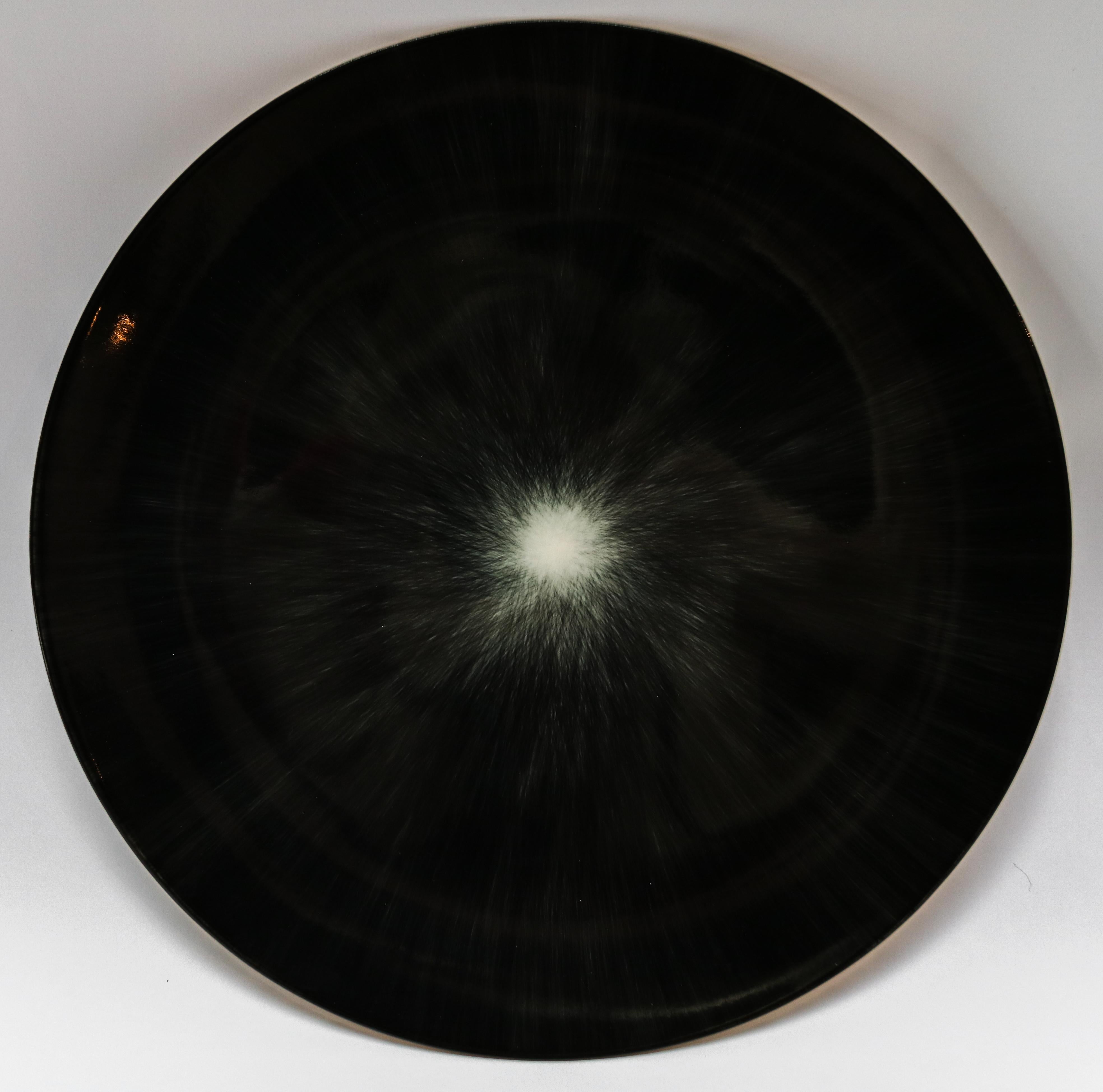 Ann Demeulemeester for Serax Dé dinner plate / charger in black / off white. Hand painted with a starburst pattern.  28cm diameter x 1.8 cm high. Must be purchased in quantities of two.