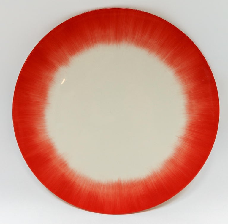 Ann Demeulemeester for Serax Dé dinner plate / charger in off white / red. Hand painted with a starburst pattern. 28cm diameter x 1.8 cm high. Must be purchased in quantities of two.