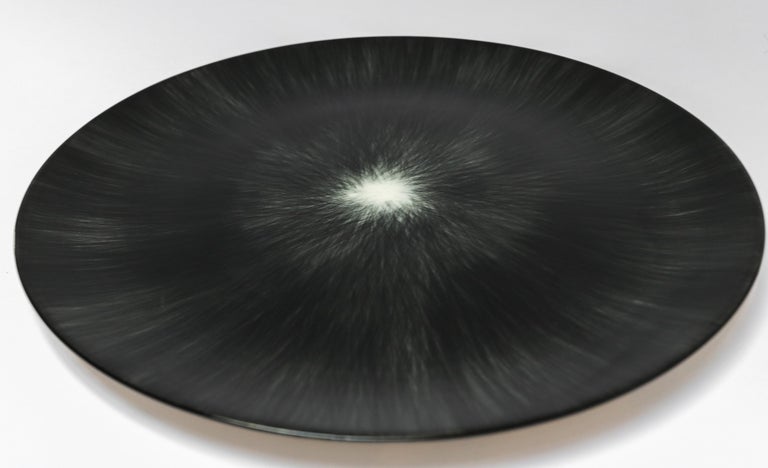Ann Demeulemeester for Serax Dé dinner plate in black / off white. Hand painted with a starburst pattern. Measures: 24cm diameter x 1.1 cm high. Must be purchased in quantities of two.