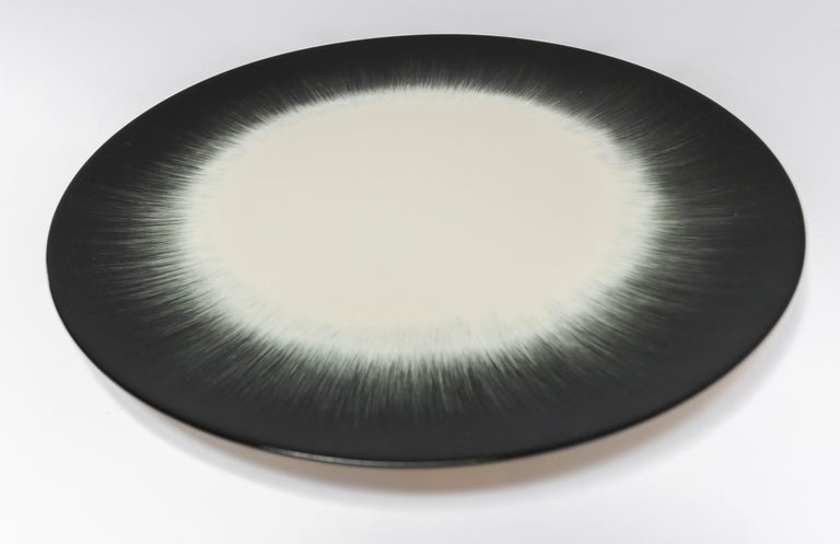 Ann Demeulemeester for Serax Dé dinner plate in off white / black. Hand painted with a starburst pattern. Measures: 24cm diameter x 1.1 cm high. Must be purchased in quantities of two.