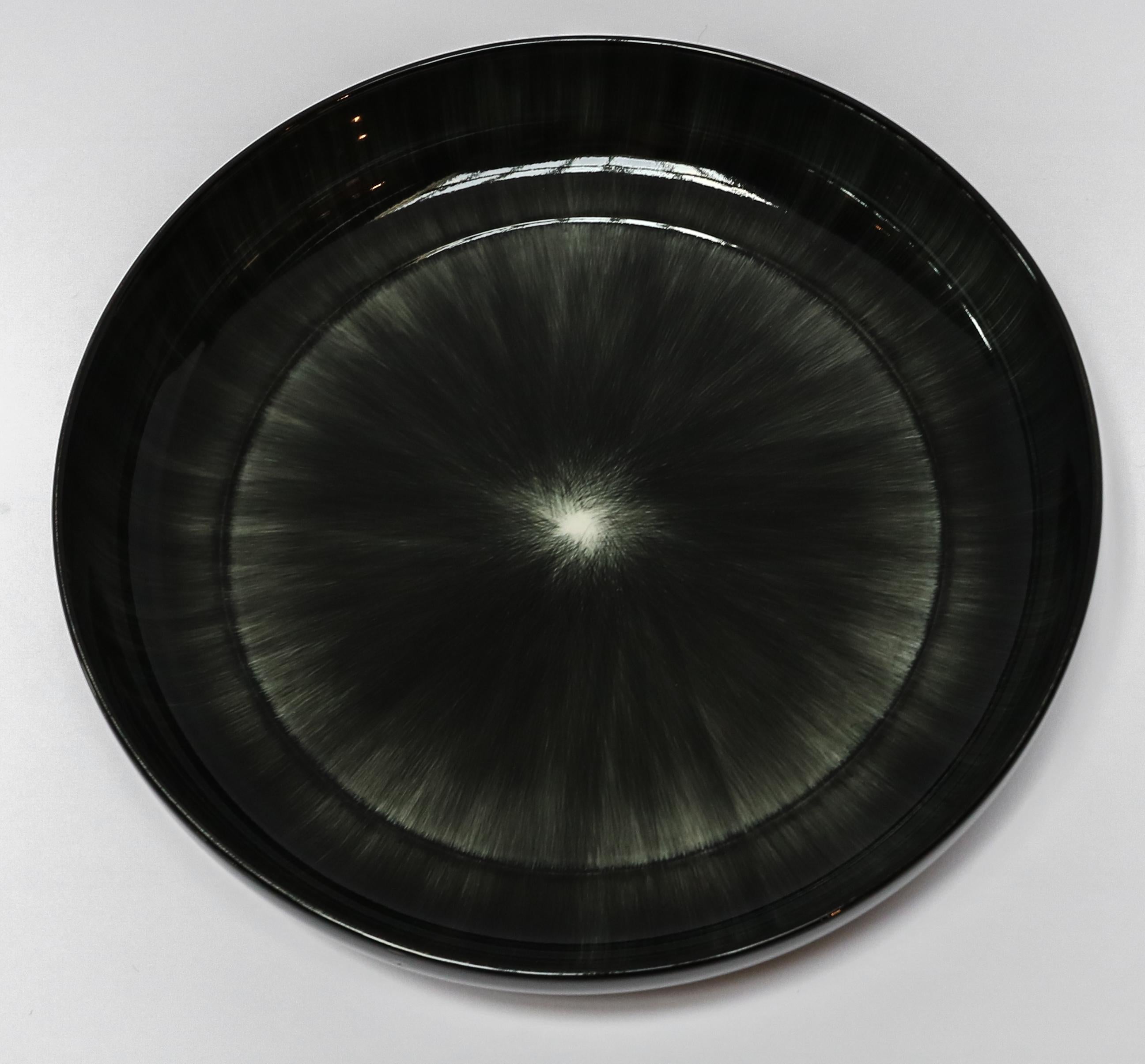Ann Demeulemeester for Serax Dé large high plate / bowl in black / off white. Hand painted with a starburst pattern. Measures: 24 cm diameter x 4.2 cm high. Must be purchased in quantities of two.
