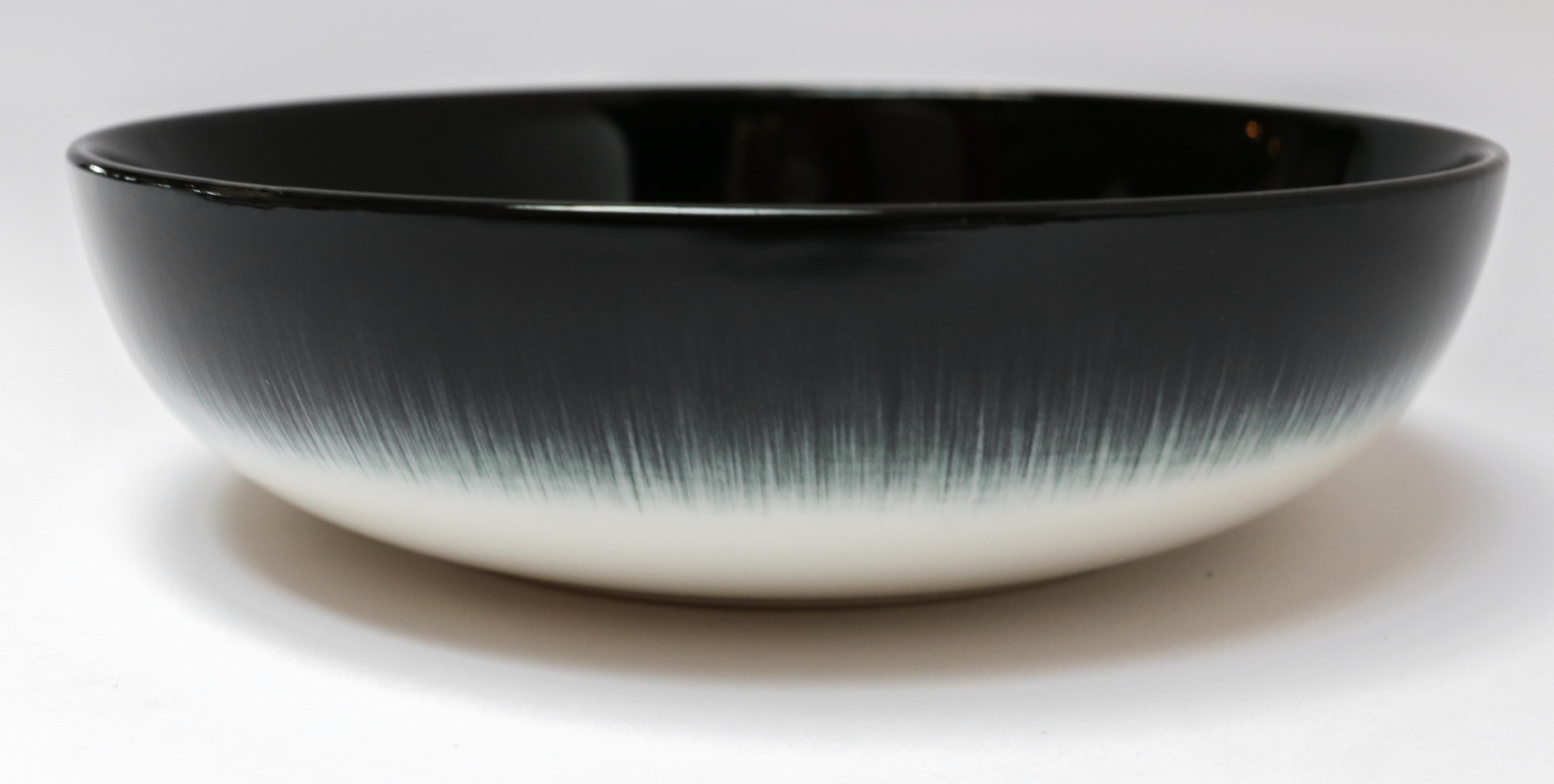 Ann Demeulemeester for Serax Dé small high plate / bowl in off white / black. Hand painted with a starburst pattern. Measures: 15.5cm diameter x 4.2 cm high. Must be purchased in quantities of two.