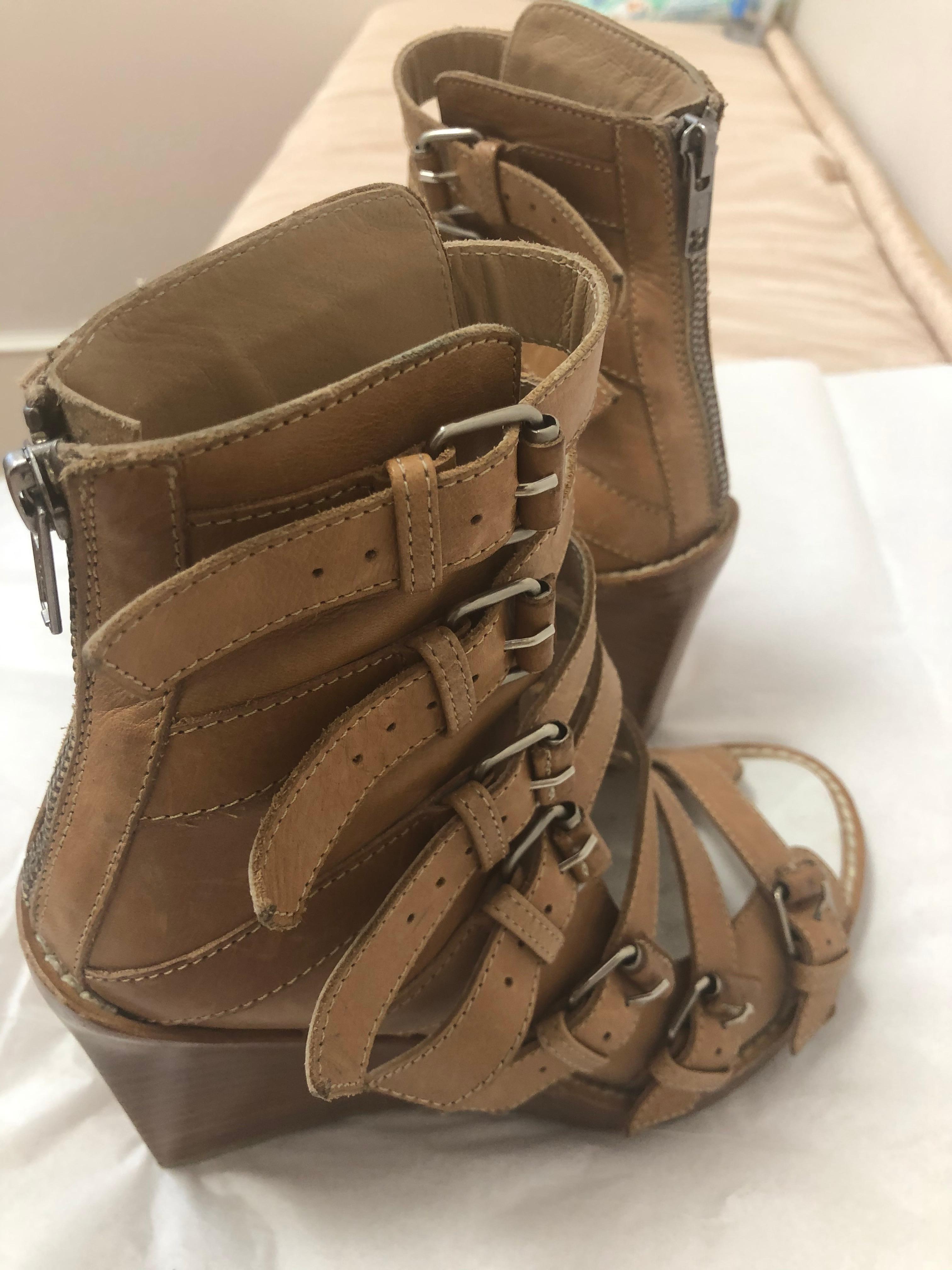 In great condition, these Ann Demeulemeester tan leather open toe gladiator wedges are so fashionable. They come up to your ankle, and although they have adjustable straps for easy wear, there is a zip at the centre back. No need to adjust the