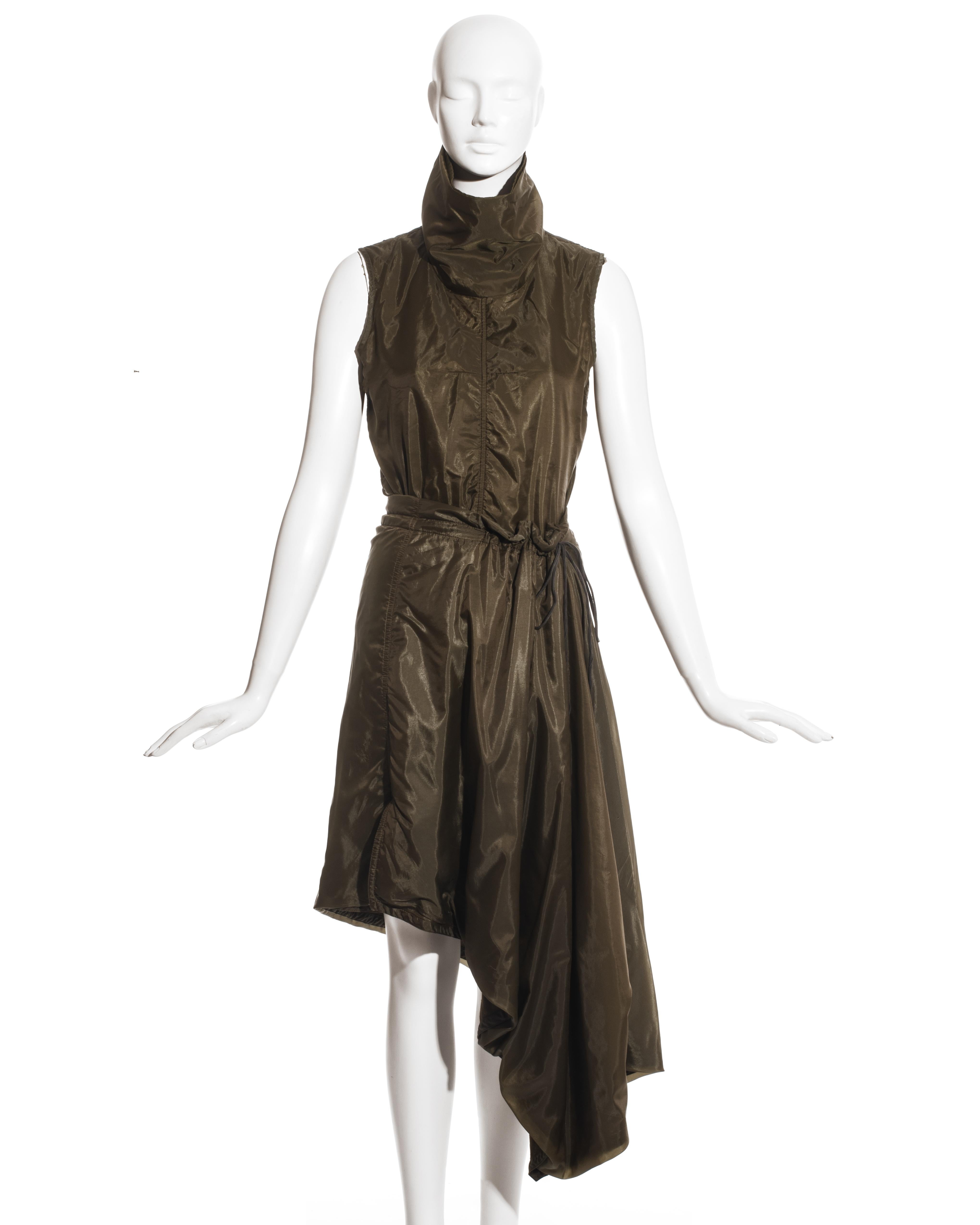 Ann Demeulemeester green nylon backed in cotton jersey skirt suit comprising: vest with high turtleneck collar and two-way zipper at back, drawstring mid-length skirt with asymmetric hanging drape and small leg slit. 

Fall-Winter 2000