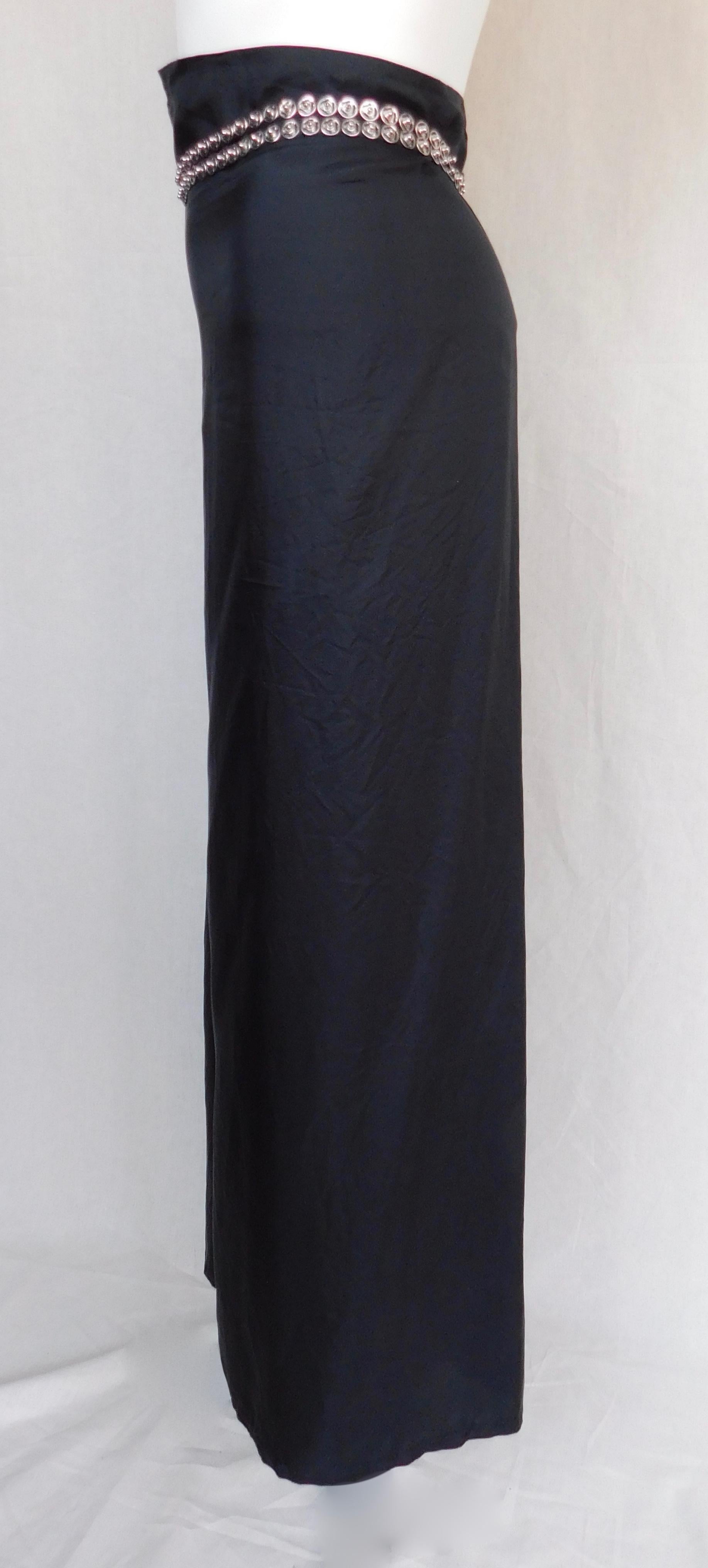 Ann Demeulemeester long black wrap around skirt with attached belt sash made of multiple steel snaps. The size is marked EU 42, but Because of the wrap around nature of this skirt it is  