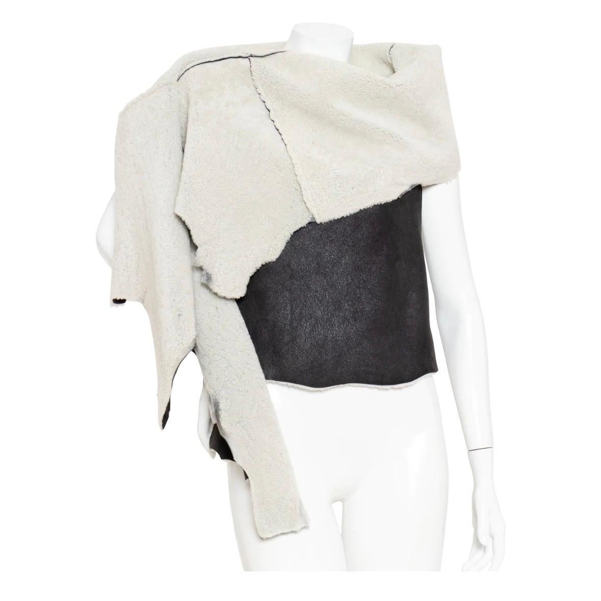 Shearling Black Wrap by Ann Demeulemeester
Black/Natural Light Gray
Sleeveless
Wrap top
Smooth exterior with shearling lining
Cowl neck with asymmetrical draping
Made in Italy
100% sheep fur; origin: Portugal
Size & Measurements
Approximate