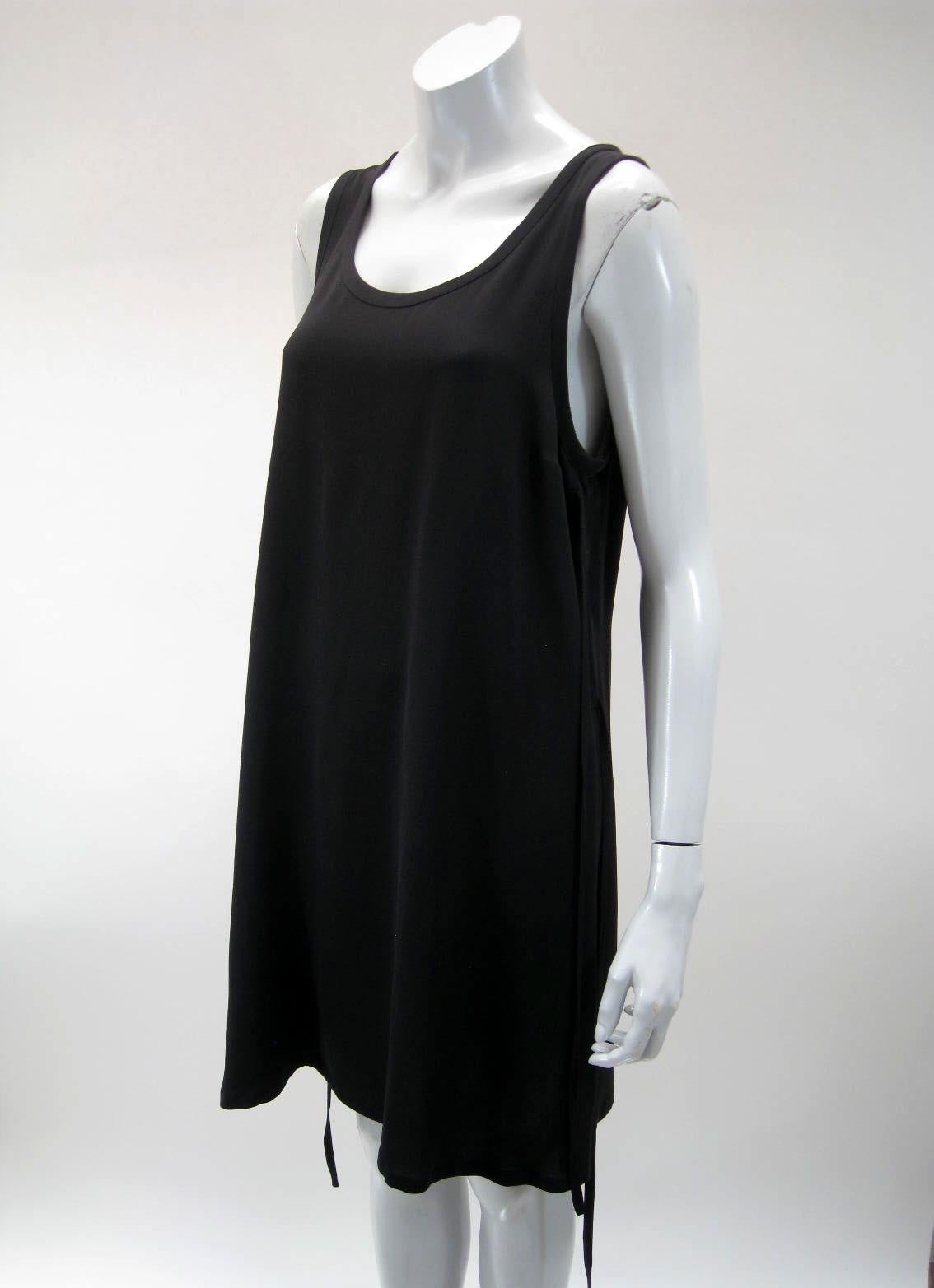 Ann Demeulemeester elegant simple black dress.

U-neck and sleeveless.

Two side ties on each side, can be tied or left loose.

Semi sheer fabric.

Fabric is silk.

Tagged size 38.

This item is in excellent vintage condition with no rips, tears or