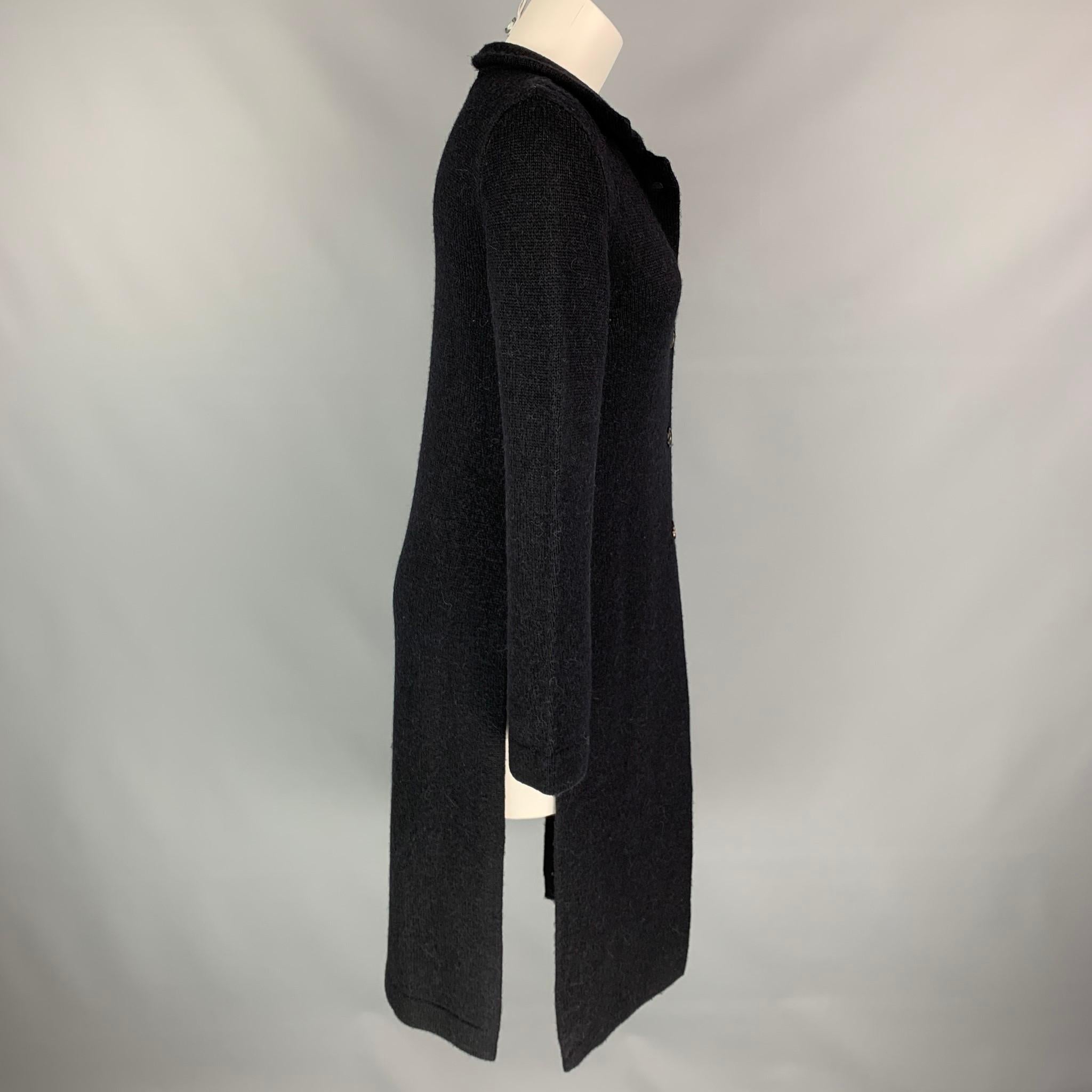 ANN DEMEULEMEESTER cardigan comes in a black knitted wool / alpaca featuring a side slits, spread collar, and a buttoned closure. Made in Belgium.

Very Good Pre-Owned Condition.
Marked: 36

Measurements:

Shoulder: 12.5 in.
Bust: 32 in.
Sleeve: 27