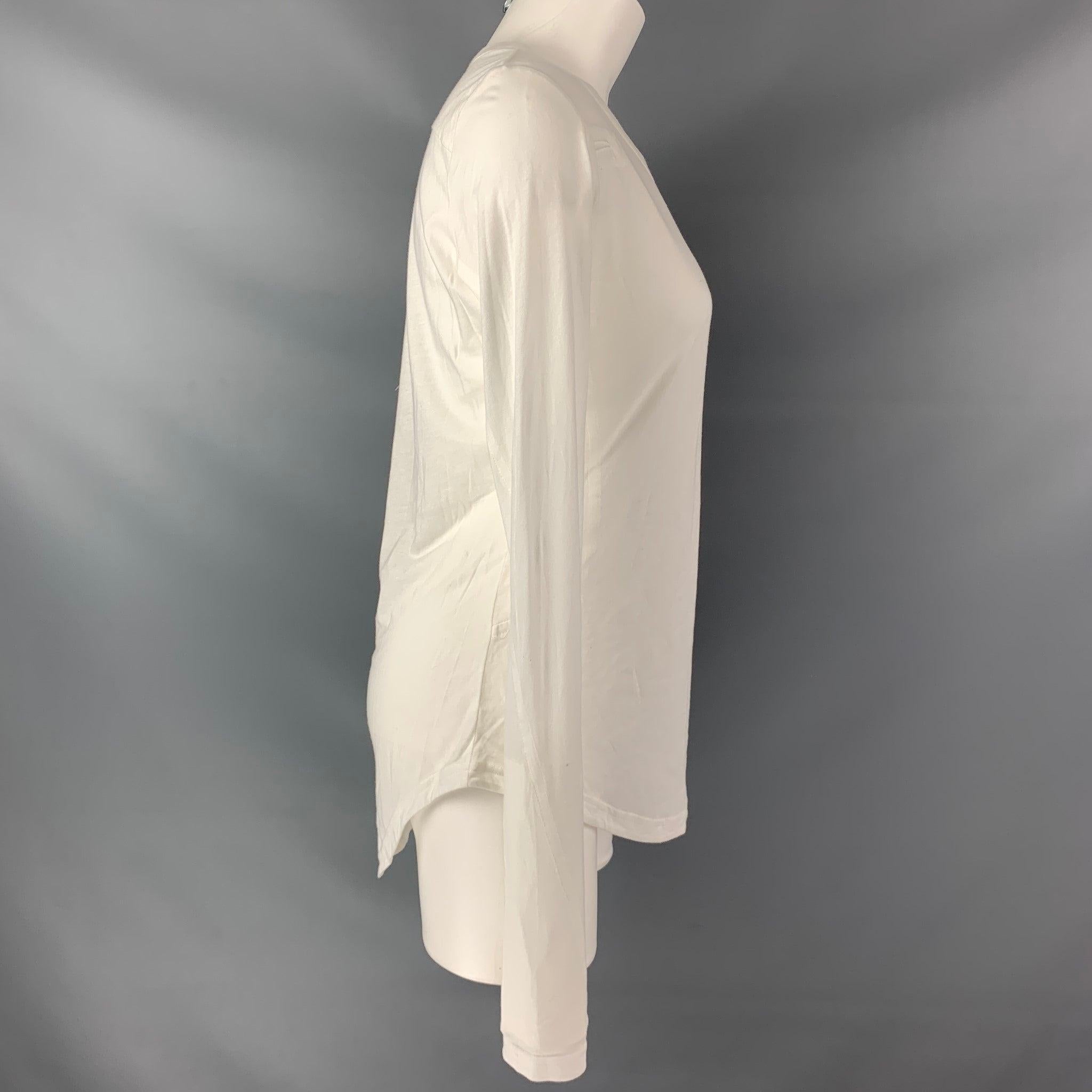ANN DEMEULEMEESTER long sleeve t-shirt comes in a white cotton solid fabric features a scoop neck and asymmetrical hem line.Very Good Pre-Owned Condition. 
 

 Marked:  36 
 

 Measurements: 
  
 Shoulder: 16 inBust:36 inSleeve:30 in
 Length:
 28