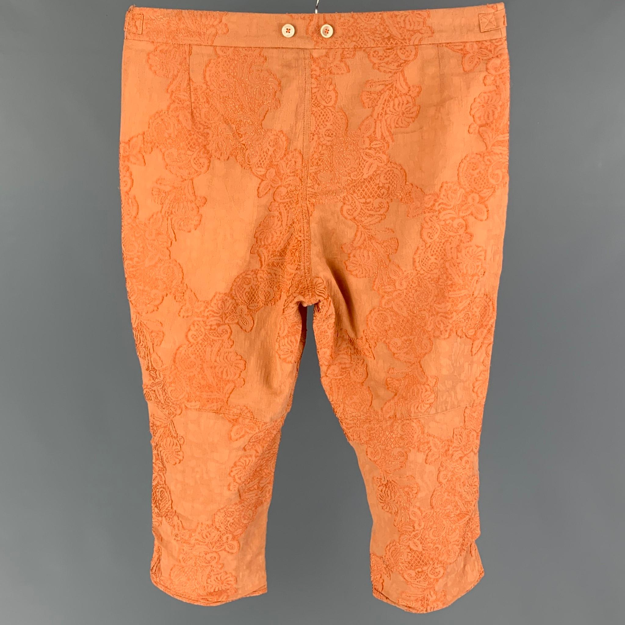ANN DEMEULEMEESTER casual pants comes in a orange cotton featuring embroidered design throughout, cropped leg, side tabs, and a button fly closure. 

Good Pre-Owned Condition. Moderate discoloration at inner rise. As-Is.
Marked: