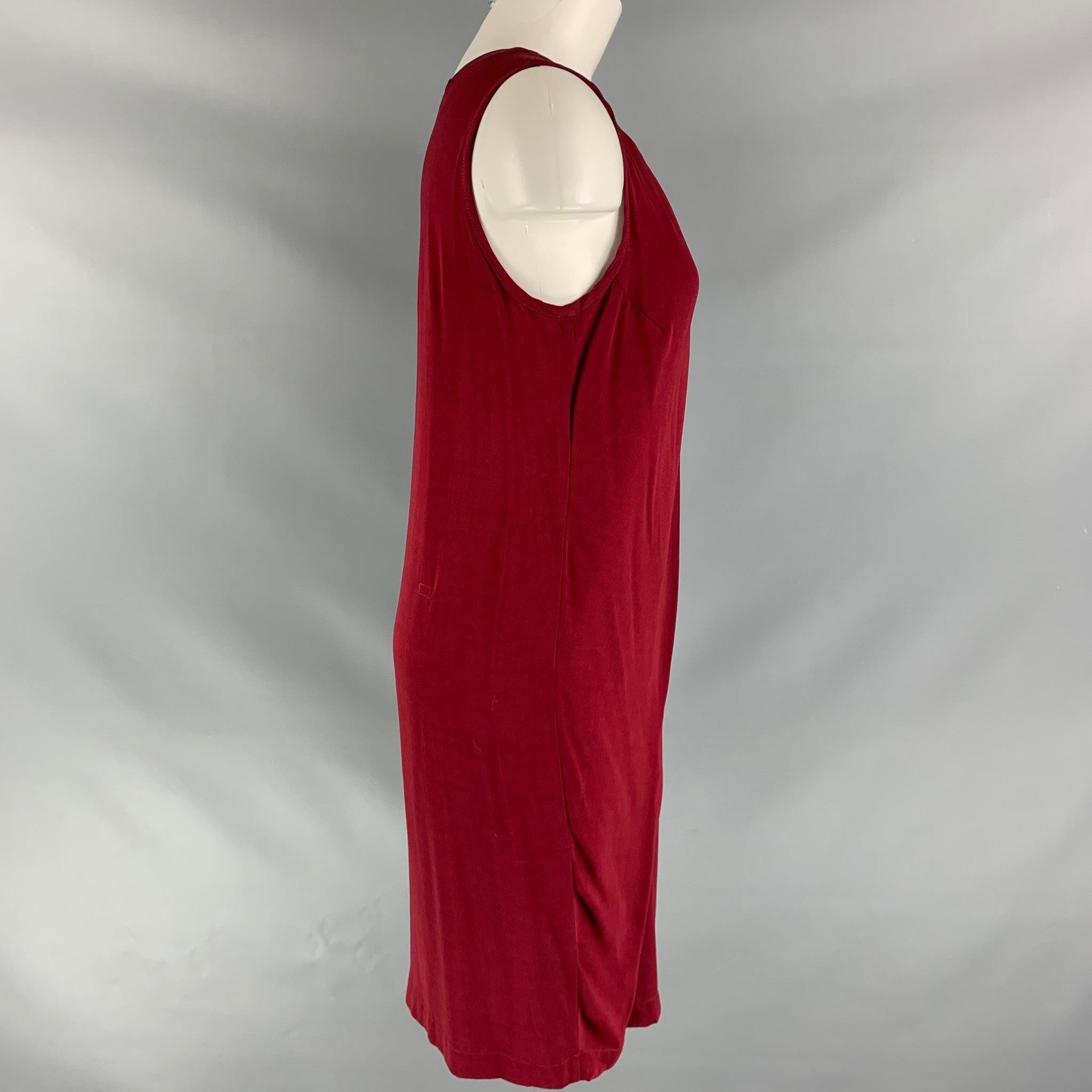 ANN DEMEULEMEESTER sleeveless casual dress comes in a burgundy rayon fabric and crew neck features an self tie. Very Good Pre-Owned Condition.
Approximately 1 inch repair at back. 

Marked:   38 

Measurements: 
 
Shoulder: 13.5 inBust: 34 inLength: