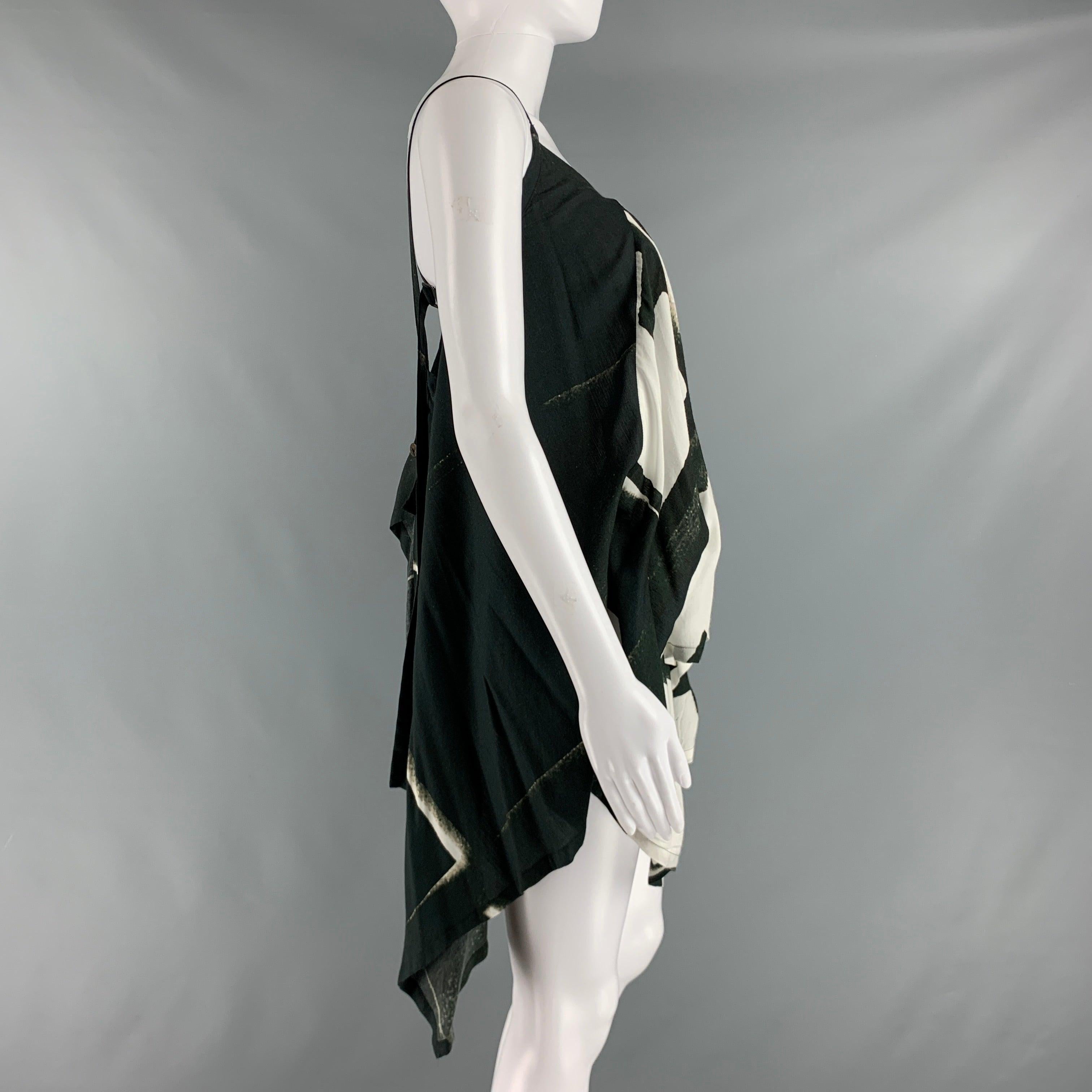 ANN DEMEULEMEESTER tank top comes in black and white abstract print viscose woven features a draped style, asymmetrical hem, and wrap up style.Very Good Pre-Owned Condition.  

Marked:   6 

Measurements: 
  Bust: 37 inLength: 30 in  
  
  
