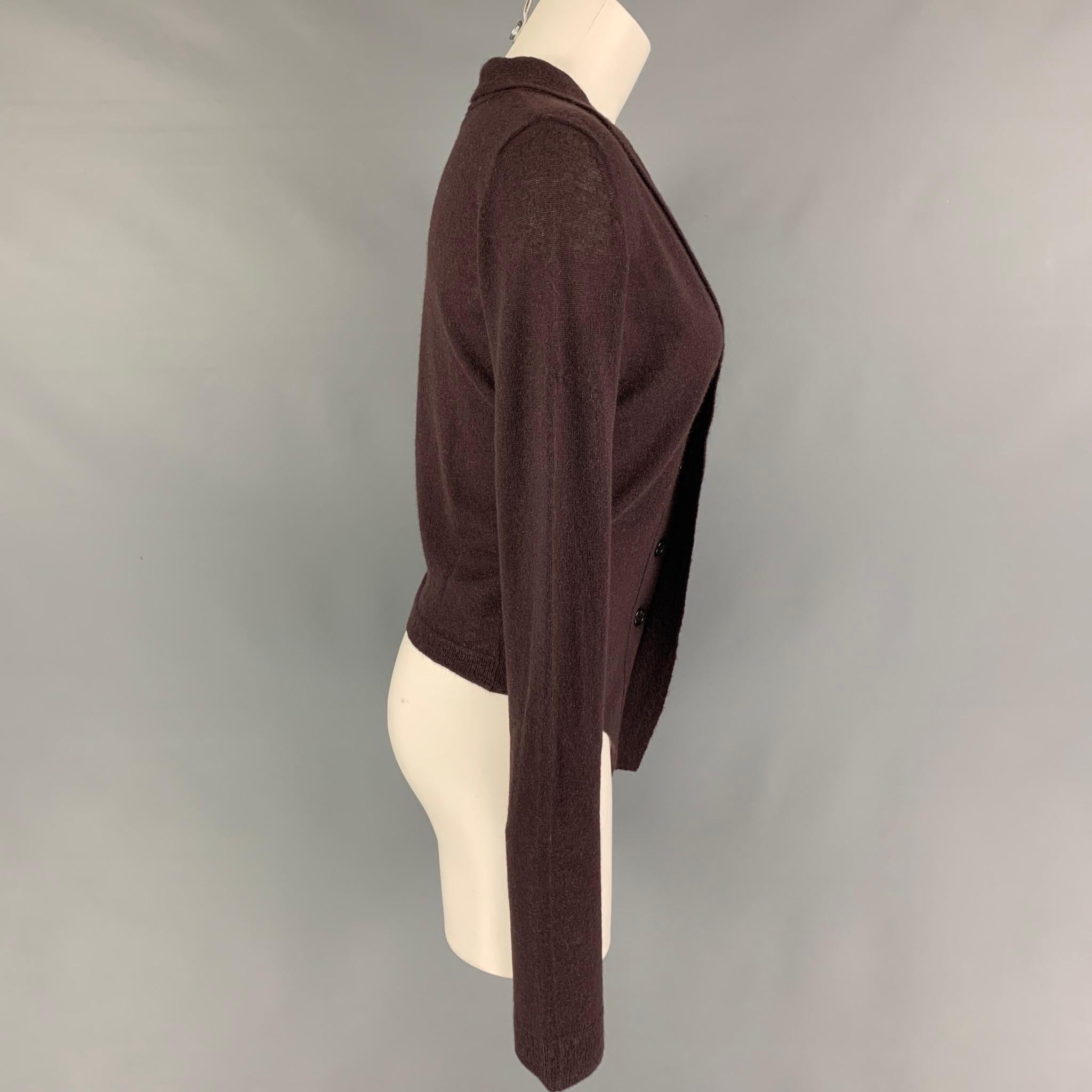 ANN DEMEULEMEESTER cardigan comes in a burgundy knitted cashmere blend featuring a shawl collar and a hidden placket closure. 

Excellent Pre-Owned Condition.
Marked: 38

Measurements:

Shoulder: 15.5 in.
Bust: 36 in.
Sleeve: 32.5 in.
Length: 18 in.