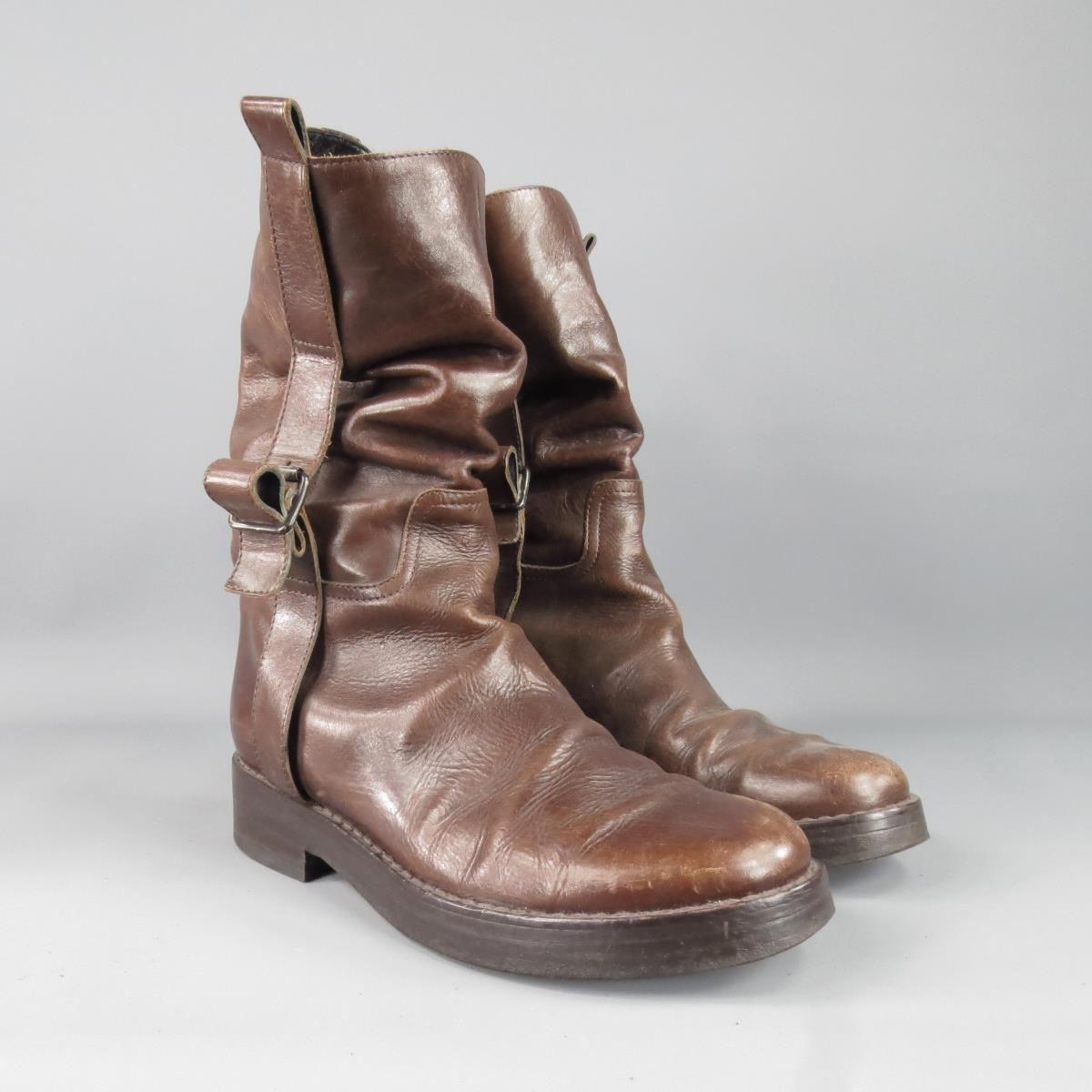 ANN DEMEULEMEESTER scrunched and distressed walking boot features unique brushes and intentional patina along a medium brown leather upper with rustic buckle accents, Made in Italy.
 
Good Pre-Owned Condition    Marked: 40
 
Measurements:
Insole: