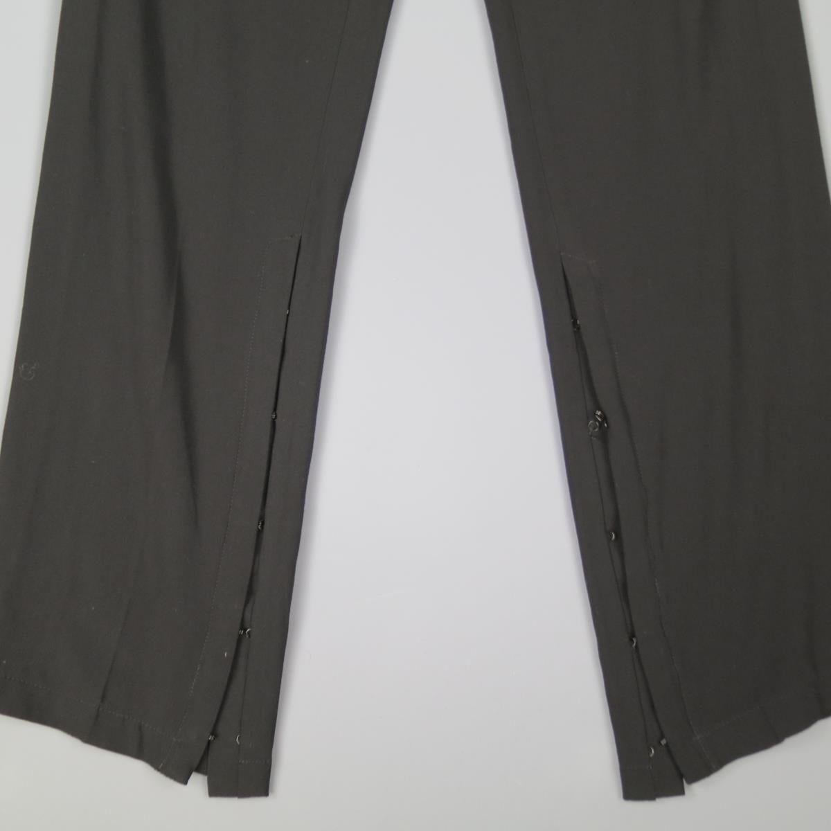 ANN DEMEULEMEESTER dress pants come in a wool viscose blend twill and feature a streamline, minimalist construction, slouchy, relaxed fit, and extended slit leg openings with hook eye closures. Made in Belgium.

Good Pre-Owned Condition.
Marked: