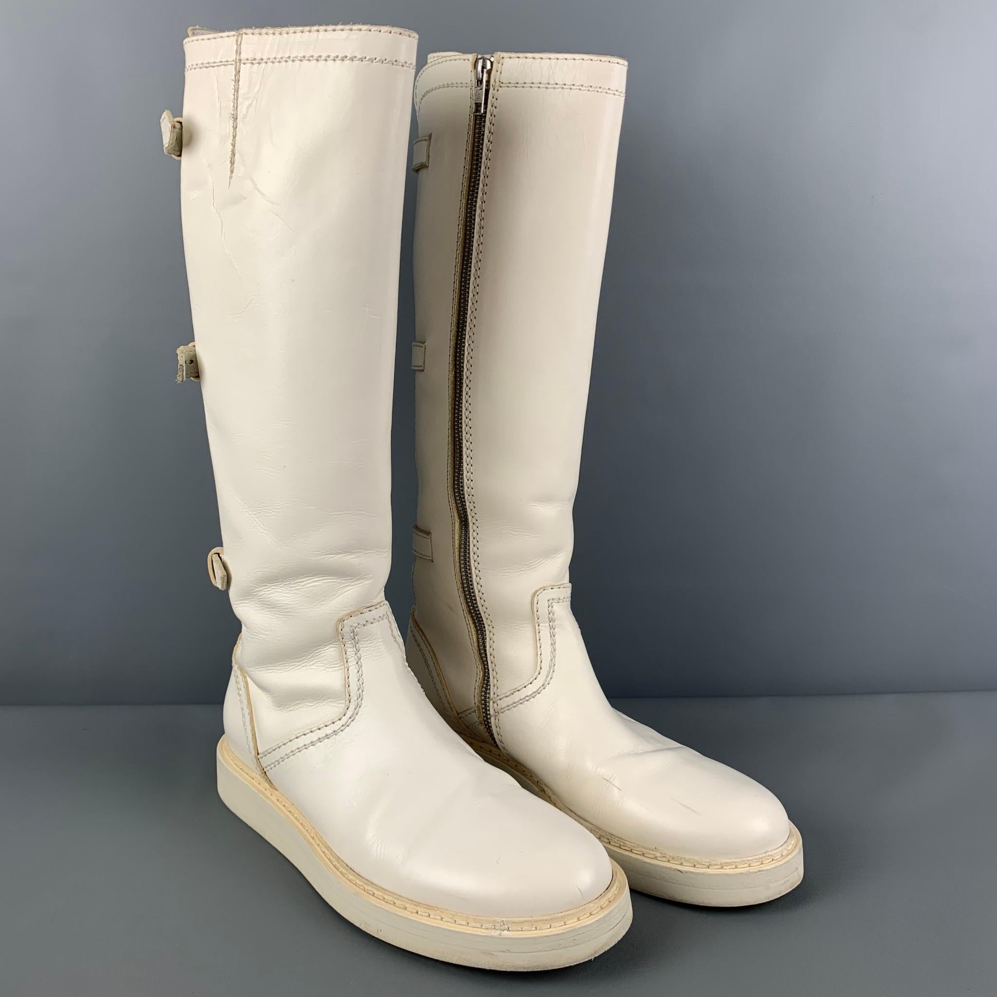 ANN DEMEULEMEESTER boots comes in a white leather featuring a round toe, knee high length, back strap details, and a side zipper closure. Made in Italy. 

Very Good Pre-Owned Condition. Light wear throughout. As-is.
Marked:
