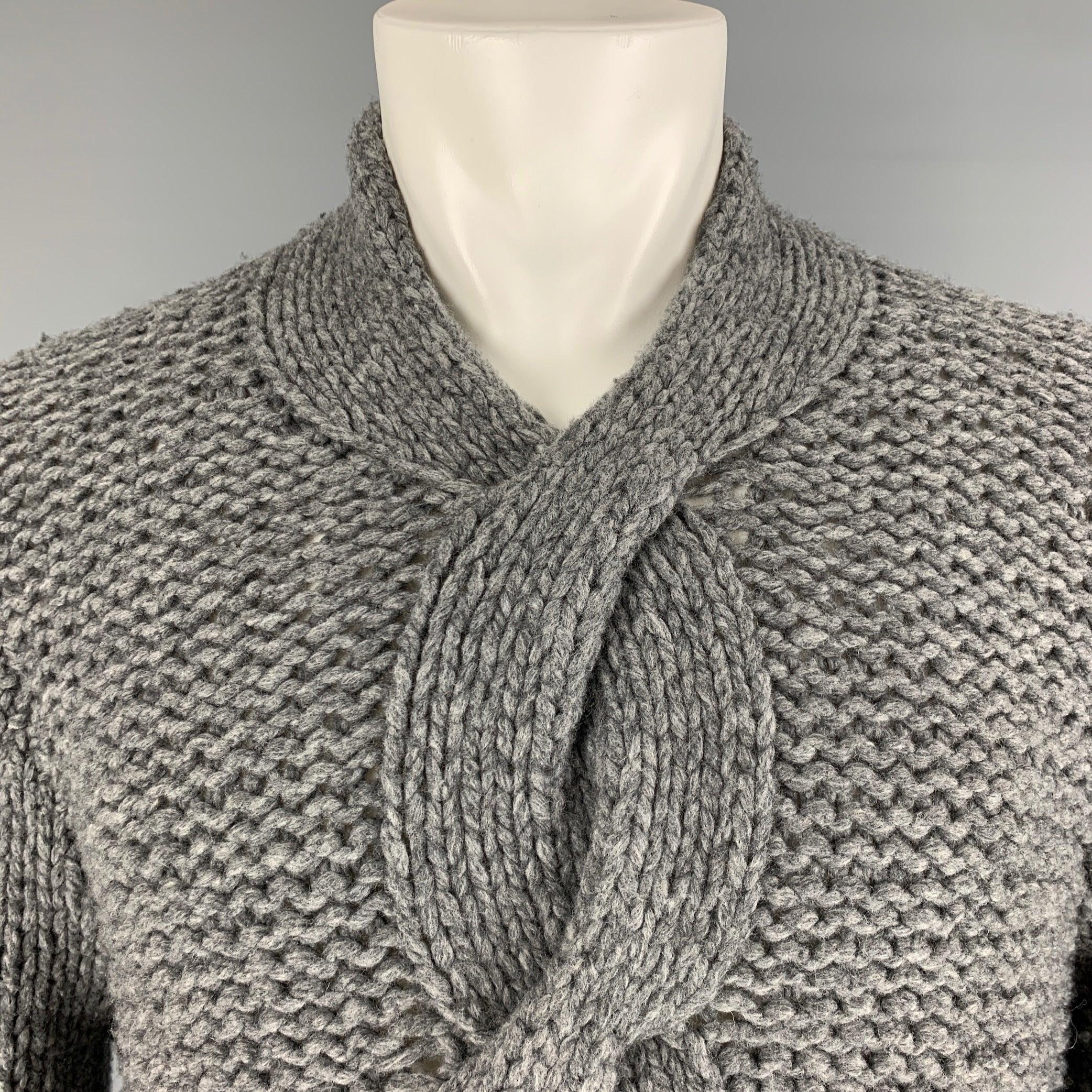 ANN DEMEULEMEESTER sweater comes in a grey virgin
 wool heavy knit material featuring a cable knit detail at front and a oversized style. Made in Belgium. Excellent Pre-Owned Condition. 

Marked:   M 

Measurements: 
 
Shoulder: 19.5 inches  Chest: