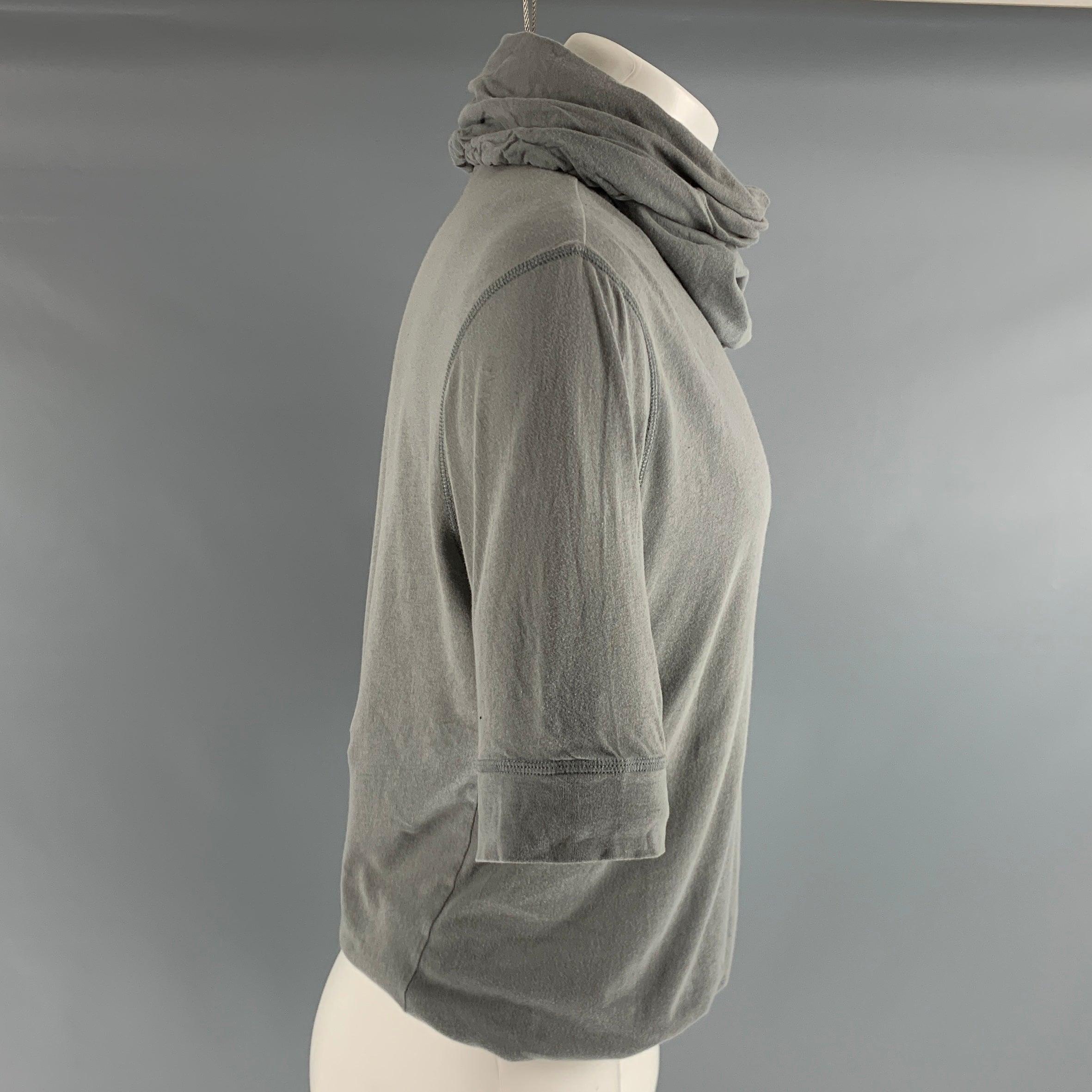 ANN DEMEULEMEESTER short sleeved pullover comes in a grey cotton jersey knit material and features a hooded style, and a 3/4 sleeves. Very Good Pre-Owned Condition. Minor signs of wear. 
  

Marked:   S 

Measurements: 
 
Shoulder: 19.5 inches