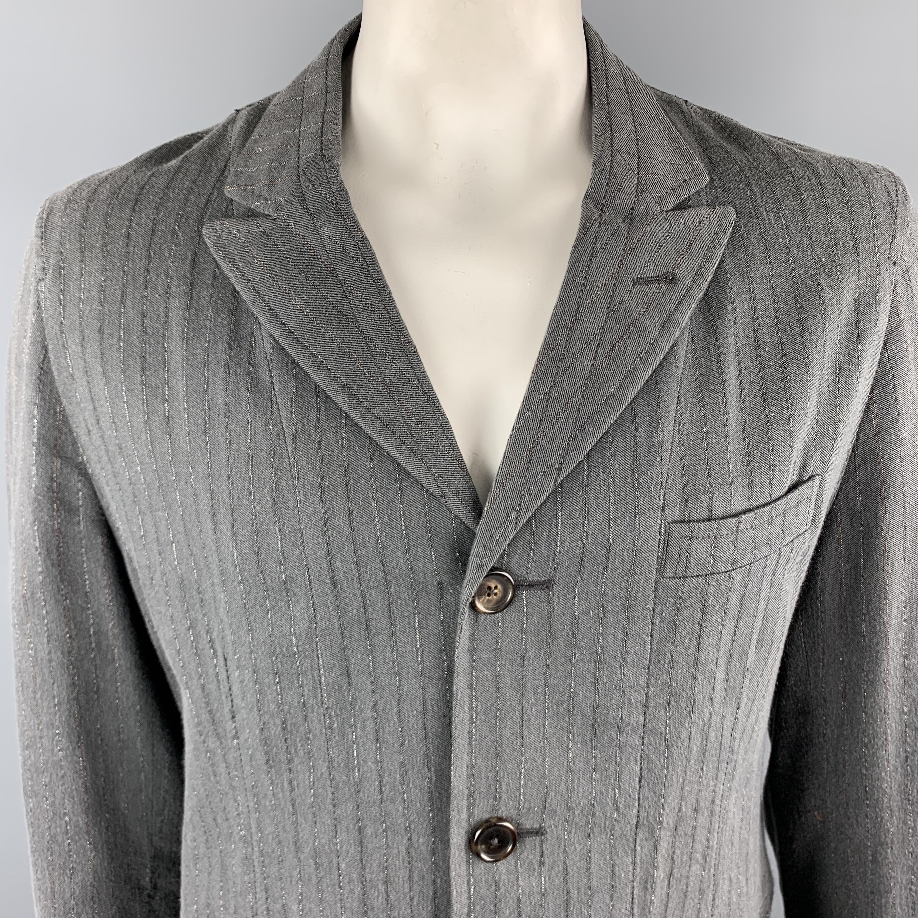 ANN DEMEULEMEESTER Jacket comes in a gray striped cotton blend featuring a peak lapel, contrast stitching, slit pockets, and a two button closure. Made in Portugal.

Excellent Pre-Owned Condition.
Marked: XL

Measurements:

Shoulder: 18.5 in.