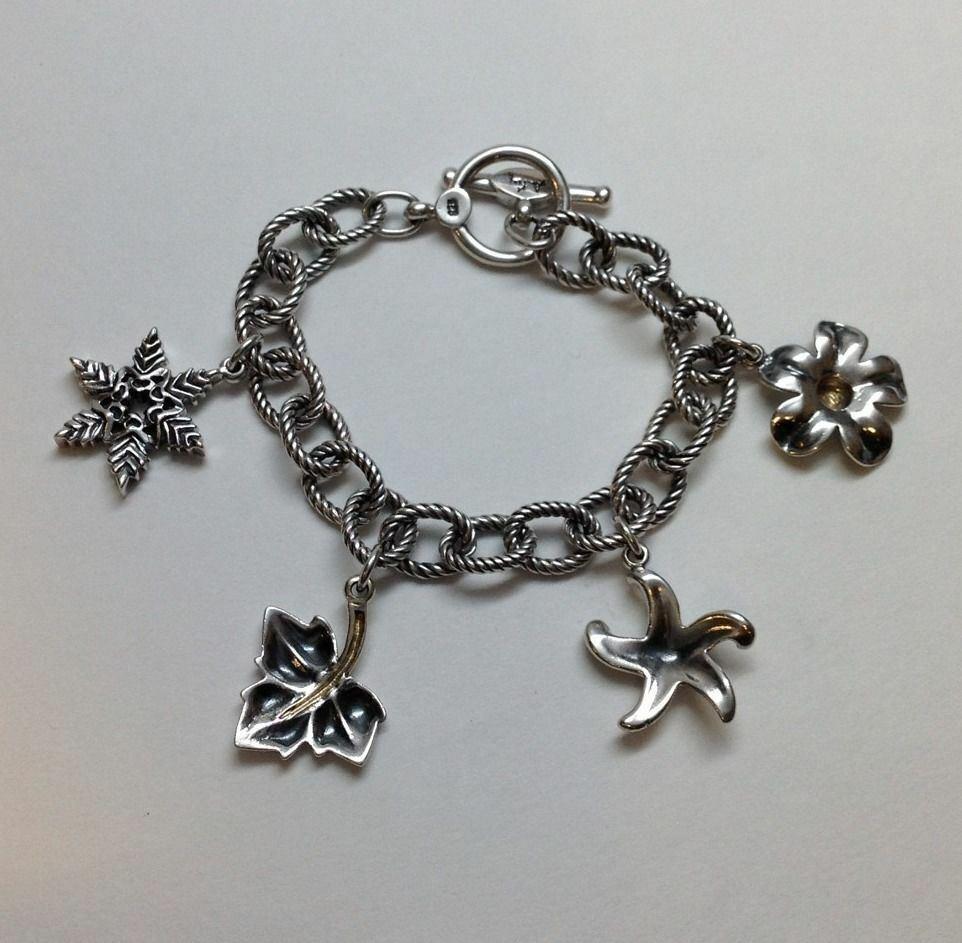 Ann King / Steven Lagos oxidized sterling silver and 18K yellow gold Four Seasons link charm bracelet.

Fits wrist size 6 1/4.

Measure with toggle clasp 7 1/4