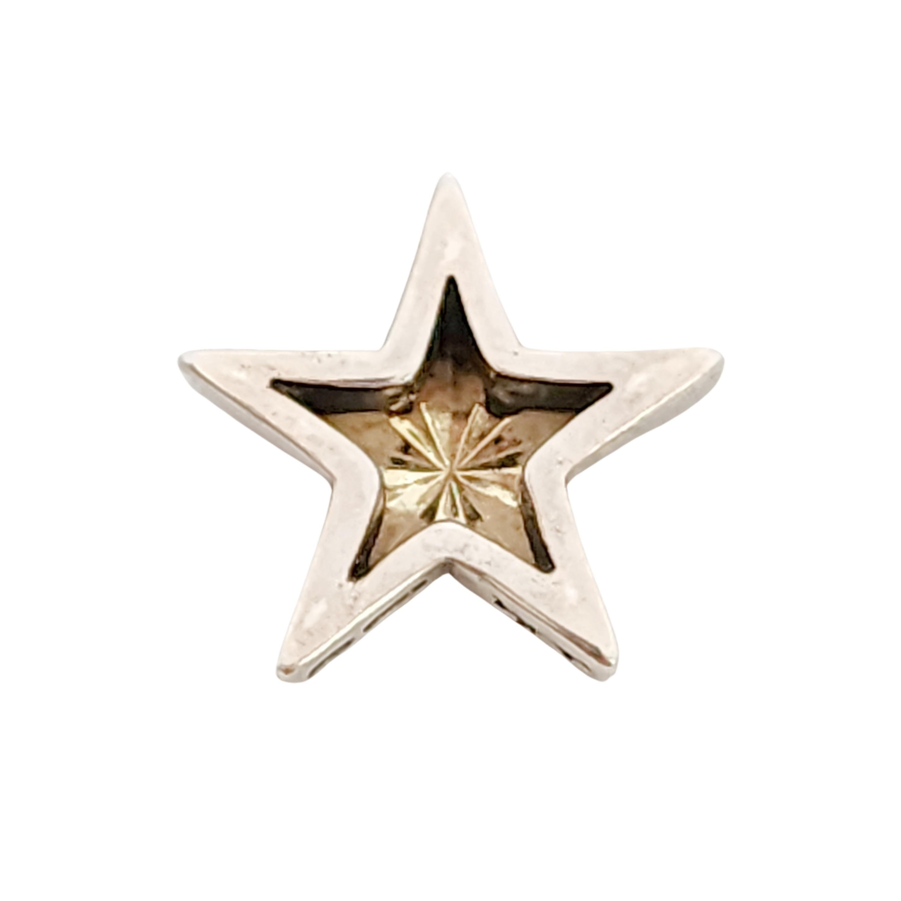 Sterling silver 18K yellow gold star pendant by Ann King.

Beautiful gold star center with a silver frame slider style pendant.

Measures approx 7/8