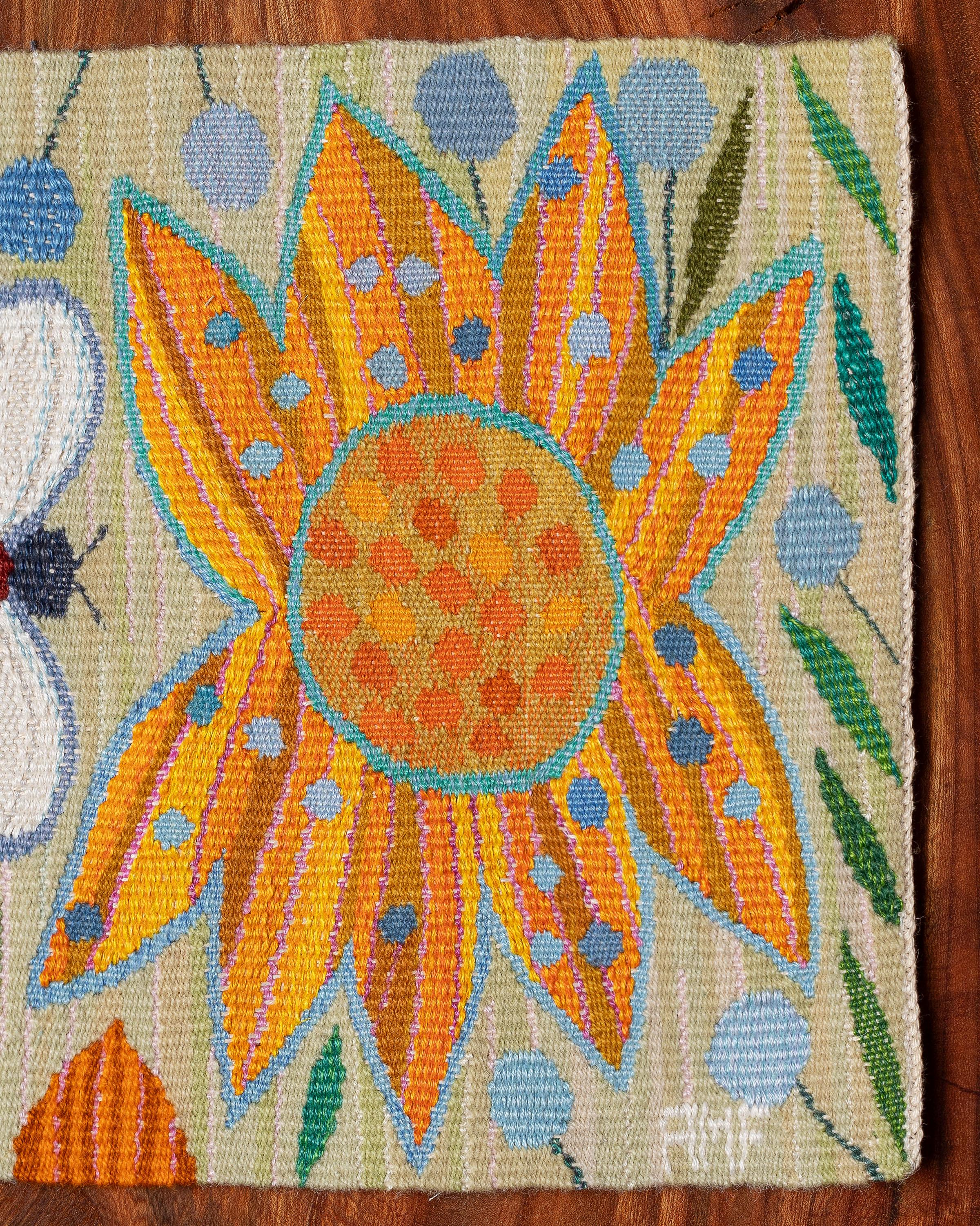 Handwoven tapestry depicting a yellow flower and bee, designed by AnnMari Forsberg in 1959. 

