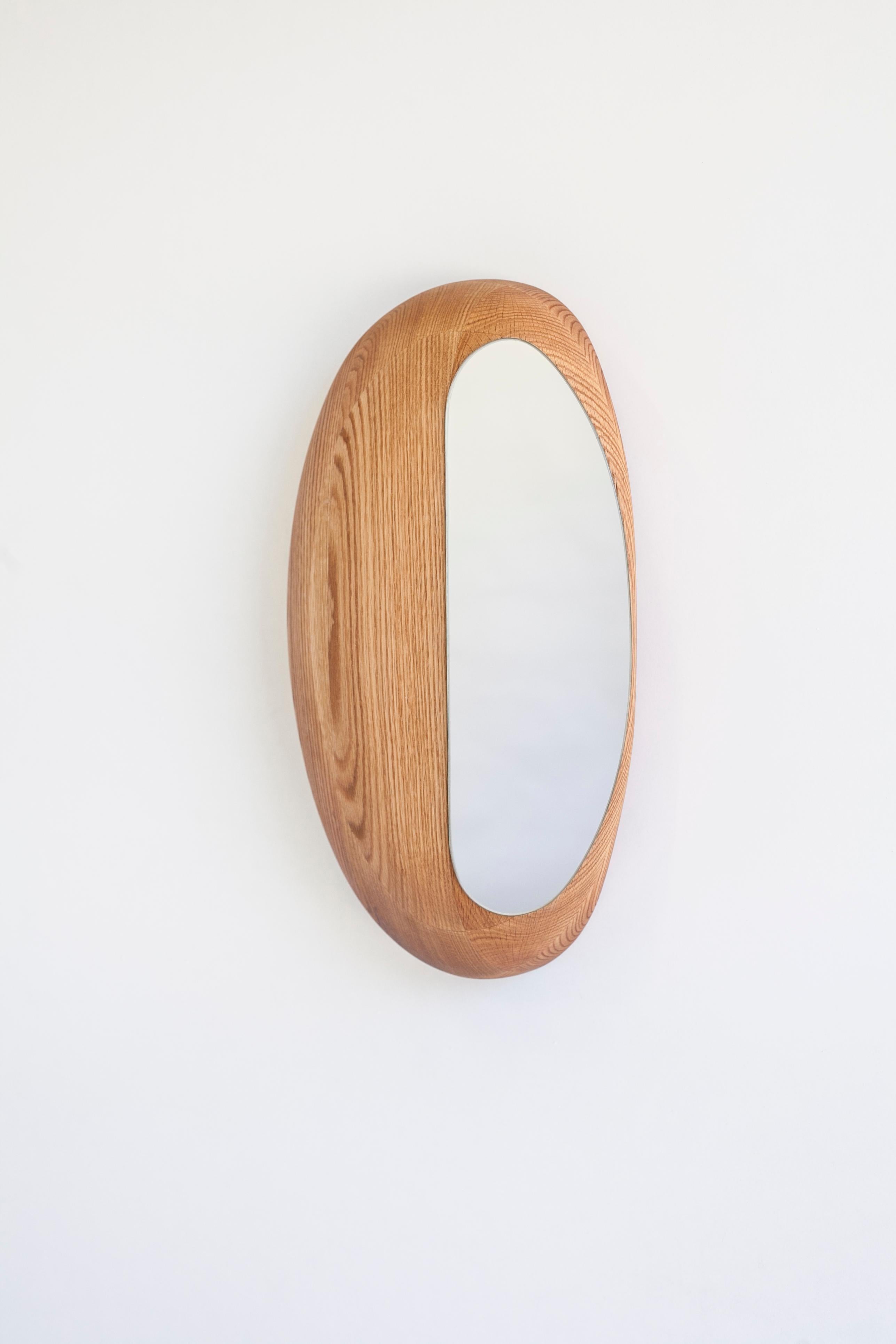 Anna Bera CD N31 mirror by Nów
Designed by Anna Bera
Dimensions: D 12 x W 30 x H 45 cm
Materials: oak wood

As an artist, woodcarver and carpenter, Anna creates wooden furniture pieces, mainly storages and cabinets crafted by hand in limited