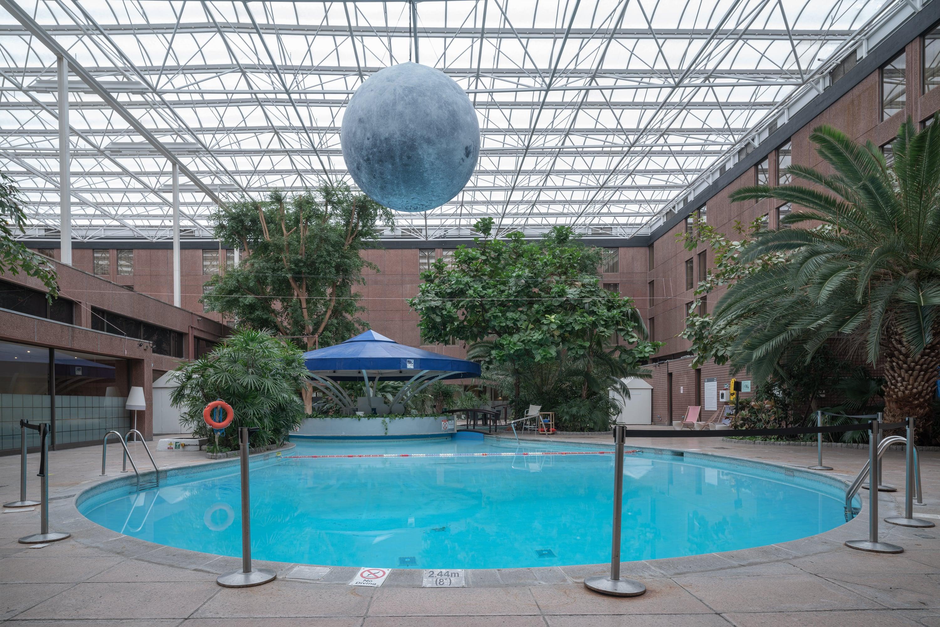 Anna Dobrovolskaya-Mints Color Photograph - Architectural Color Pool Photo: Hotel with Blue Moon-like Sphere, White Frame