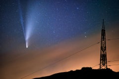 Comet approaches the Earth. Color night photo in a black wooden frame with glass