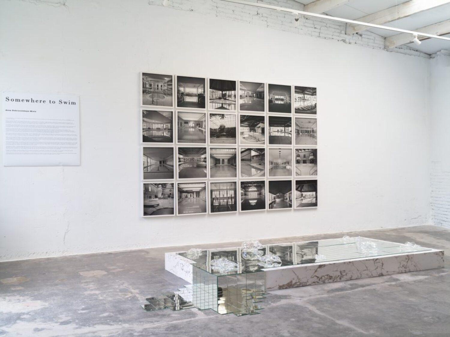 Large panel of black and white architecture photos in white frames with glass - Contemporary Photograph by Anna Dobrovolskaya-Mints