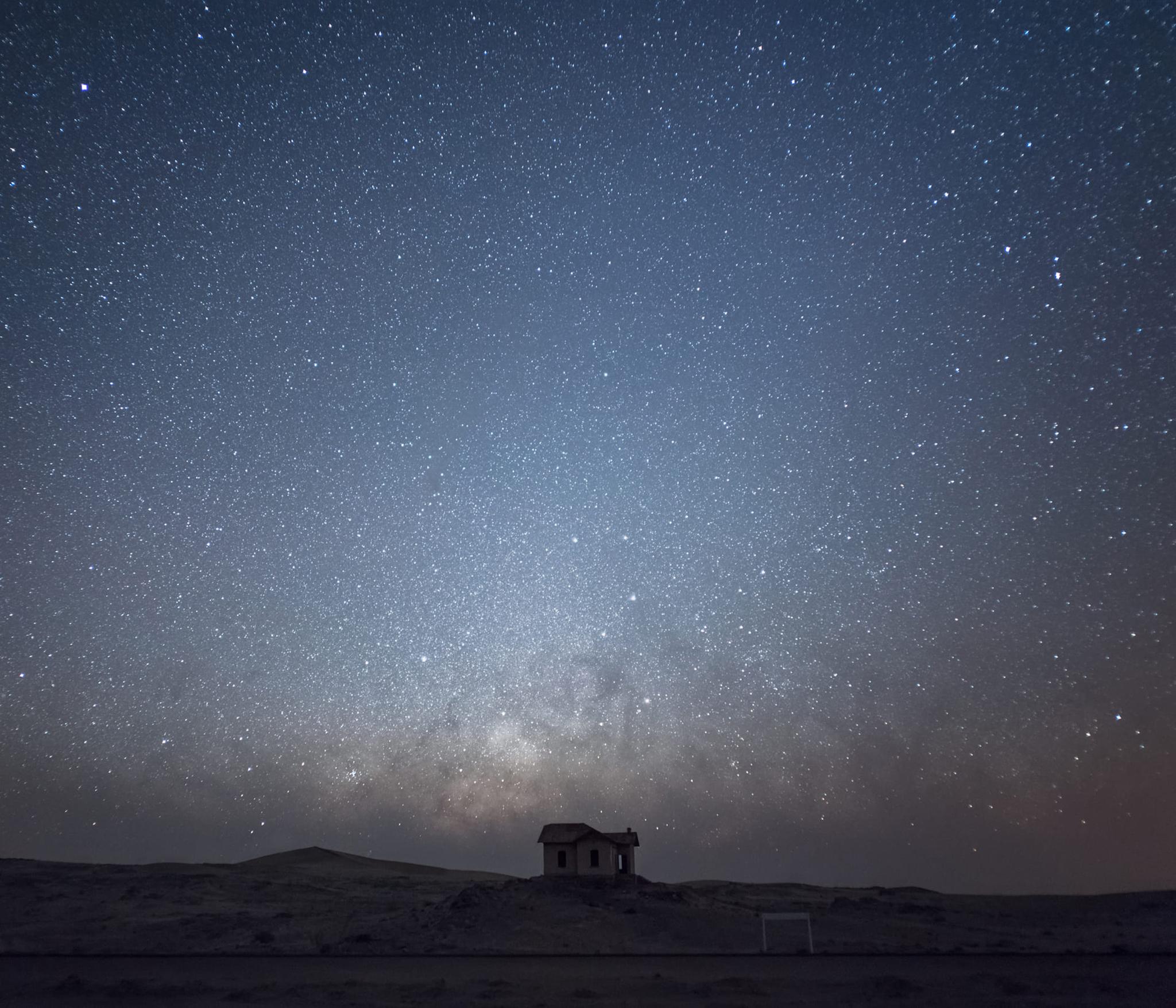 Anna Dobrovolskaya-Mints Color Photograph - House in Namib desert under Starry Sky. Dark blue square photo 