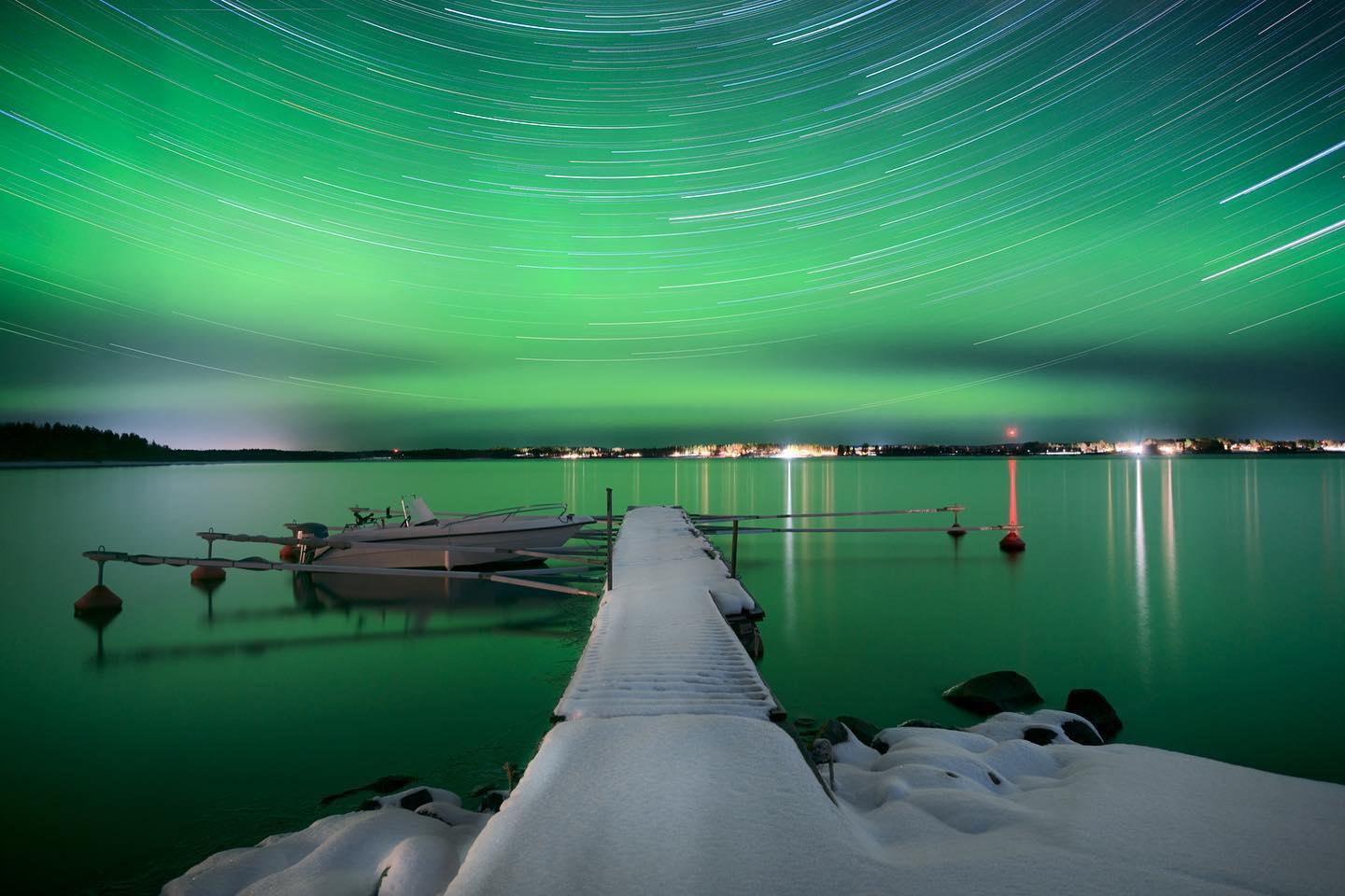 Pier in Northern Lights, Sweden. Green night photo, black frame, museum glass - Photograph by Anna Dobrovolskaya-Mints