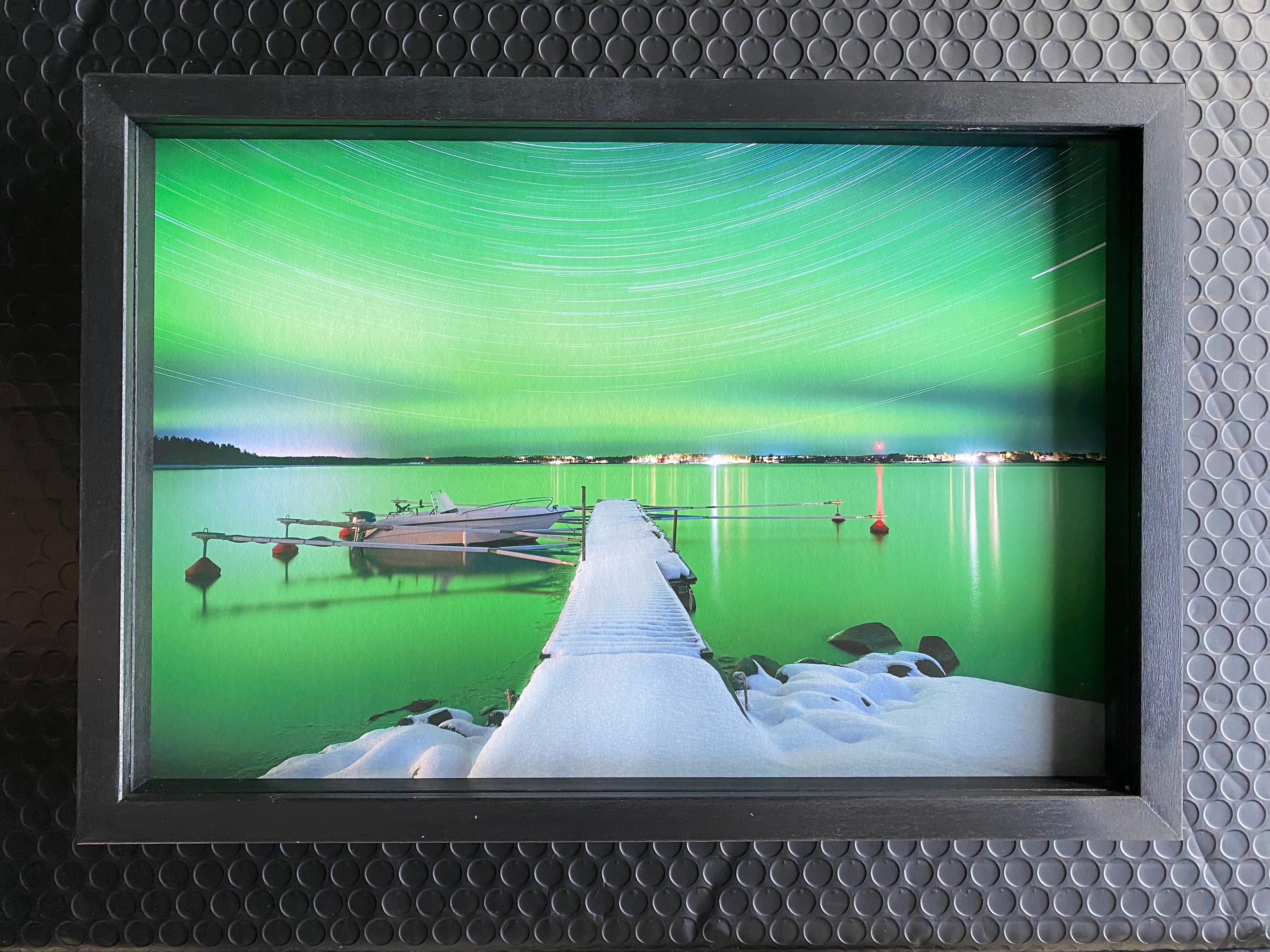 Anna Dobrovolskaya-Mints Color Photograph - Pier in Northern Lights, Sweden. Green night photo, black frame, museum glass