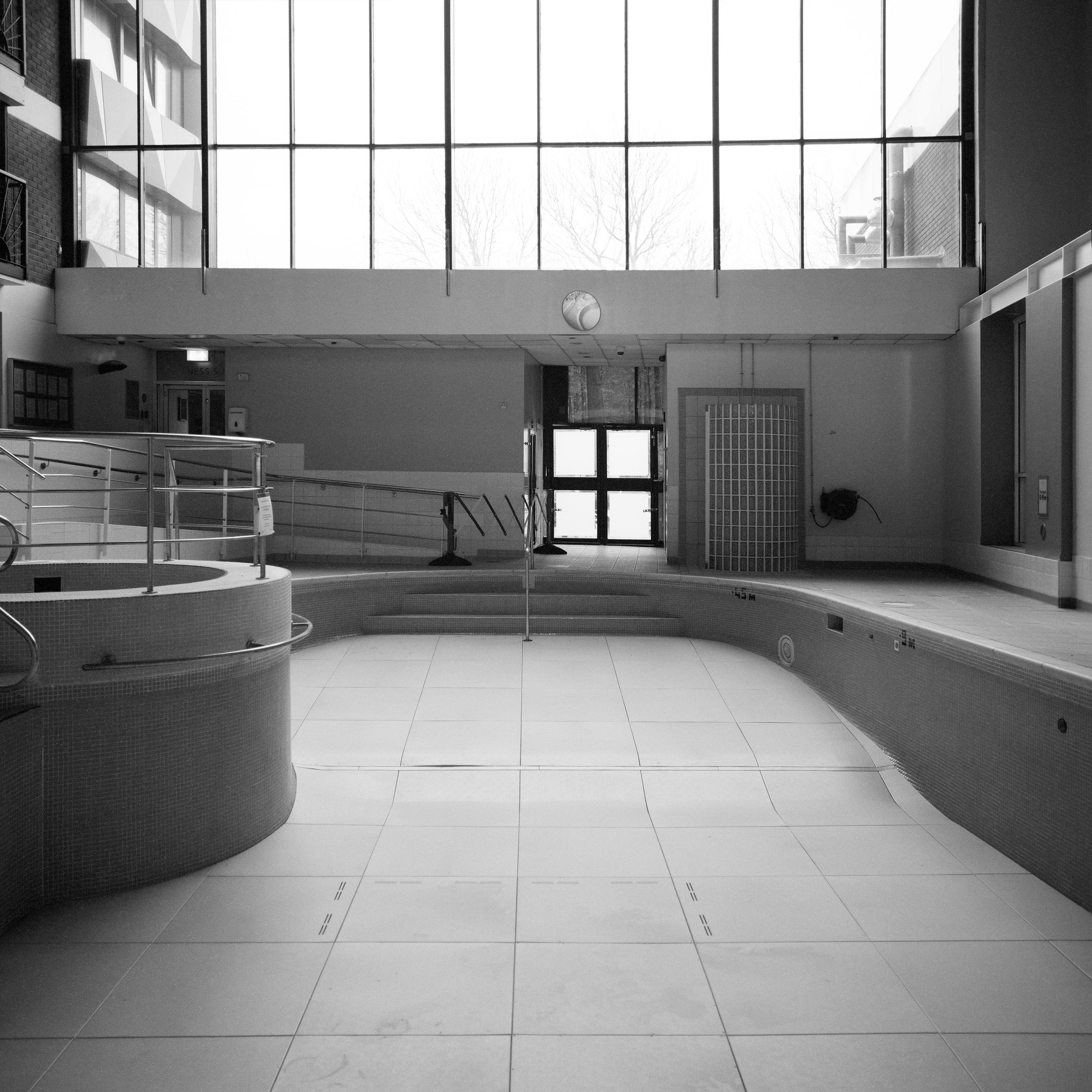 Anna Dobrovolskaya-Mints Black and White Photograph - Monochrome Square Architecture Photography: Empty Swimming Pool Design.