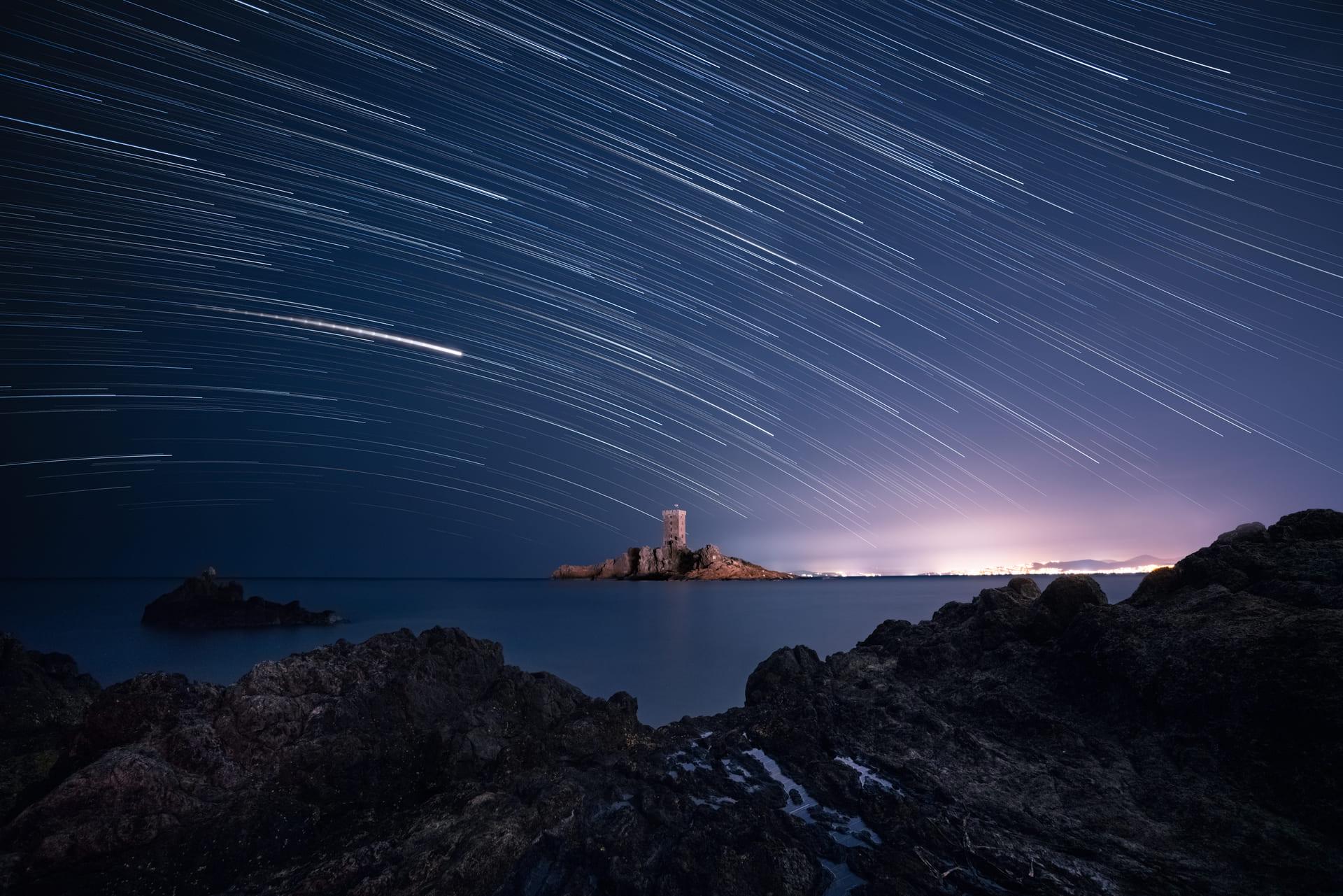 Star-trails over a castle in France. Blue photo by Anna Dobrovolskaya-Mints