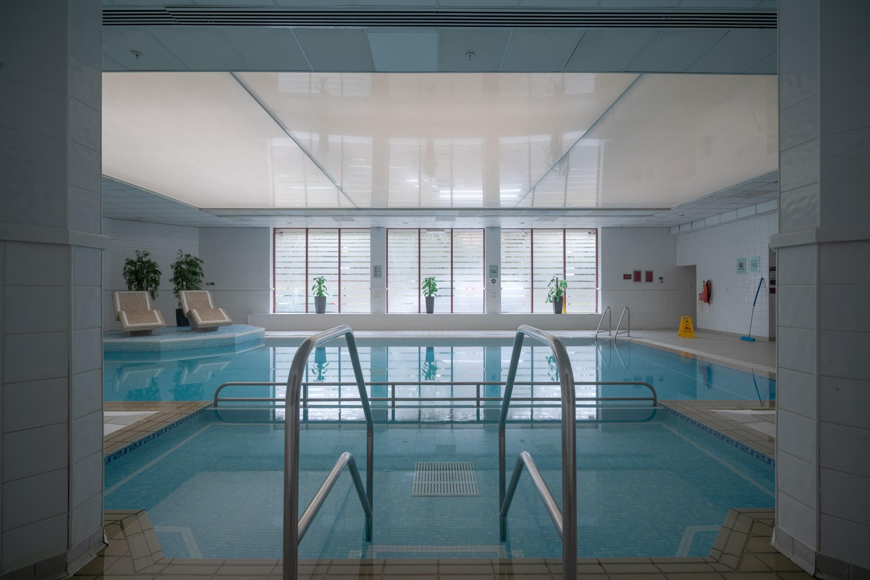Anna Dobrovolskaya-Mints Color Photograph - Architectural photo of a pool in a hotel in Wiltshire. White frame, museum glass