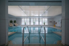 Architectural photo of a pool in a hotel in Wiltshire. White frame, museum glass