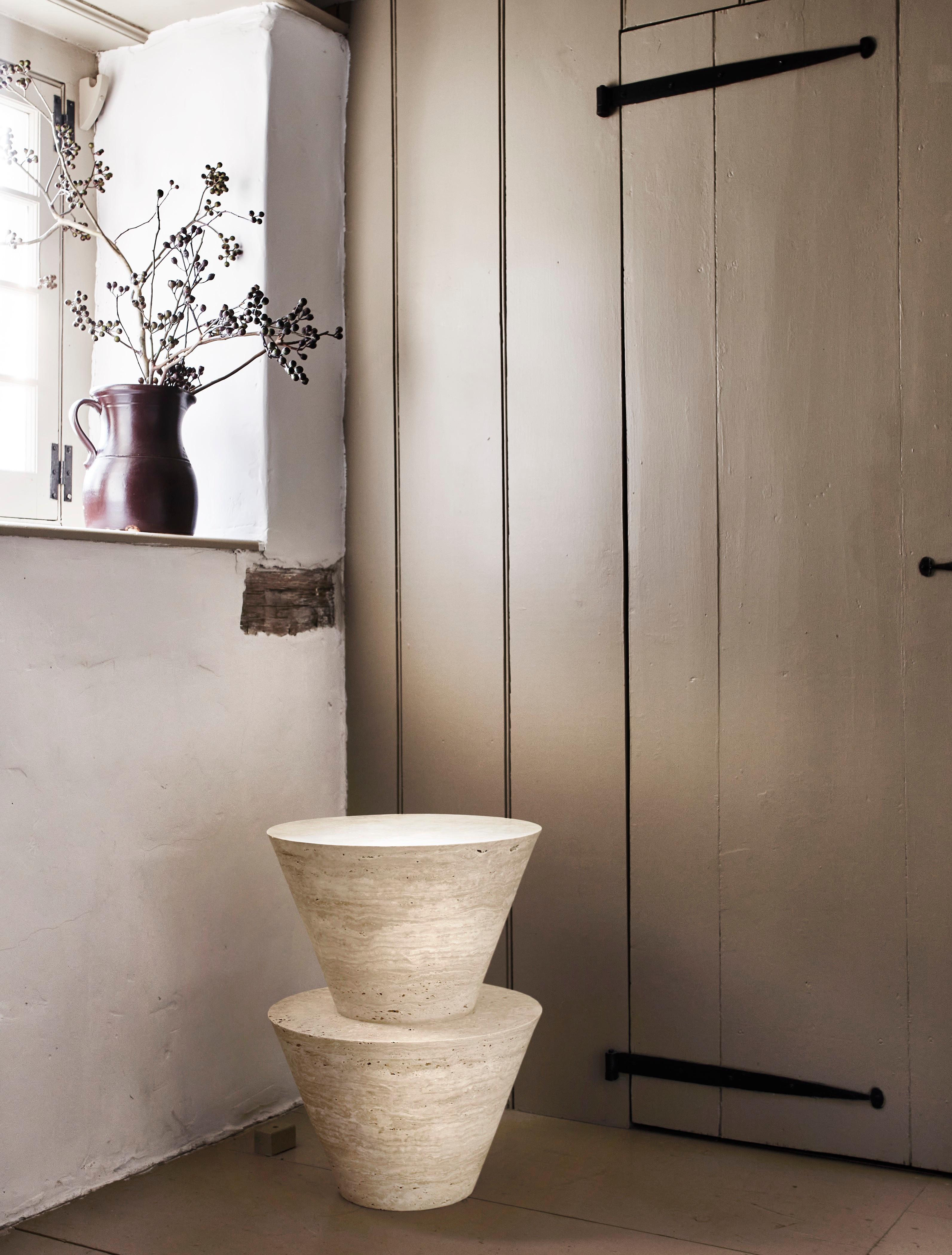 Carved from travertine or wood, these tables take their cue from carved Igbo Stools. There are four variations in the series.

Given the nature of the material, there are various shades and coloring that exist within any given block of travertine.