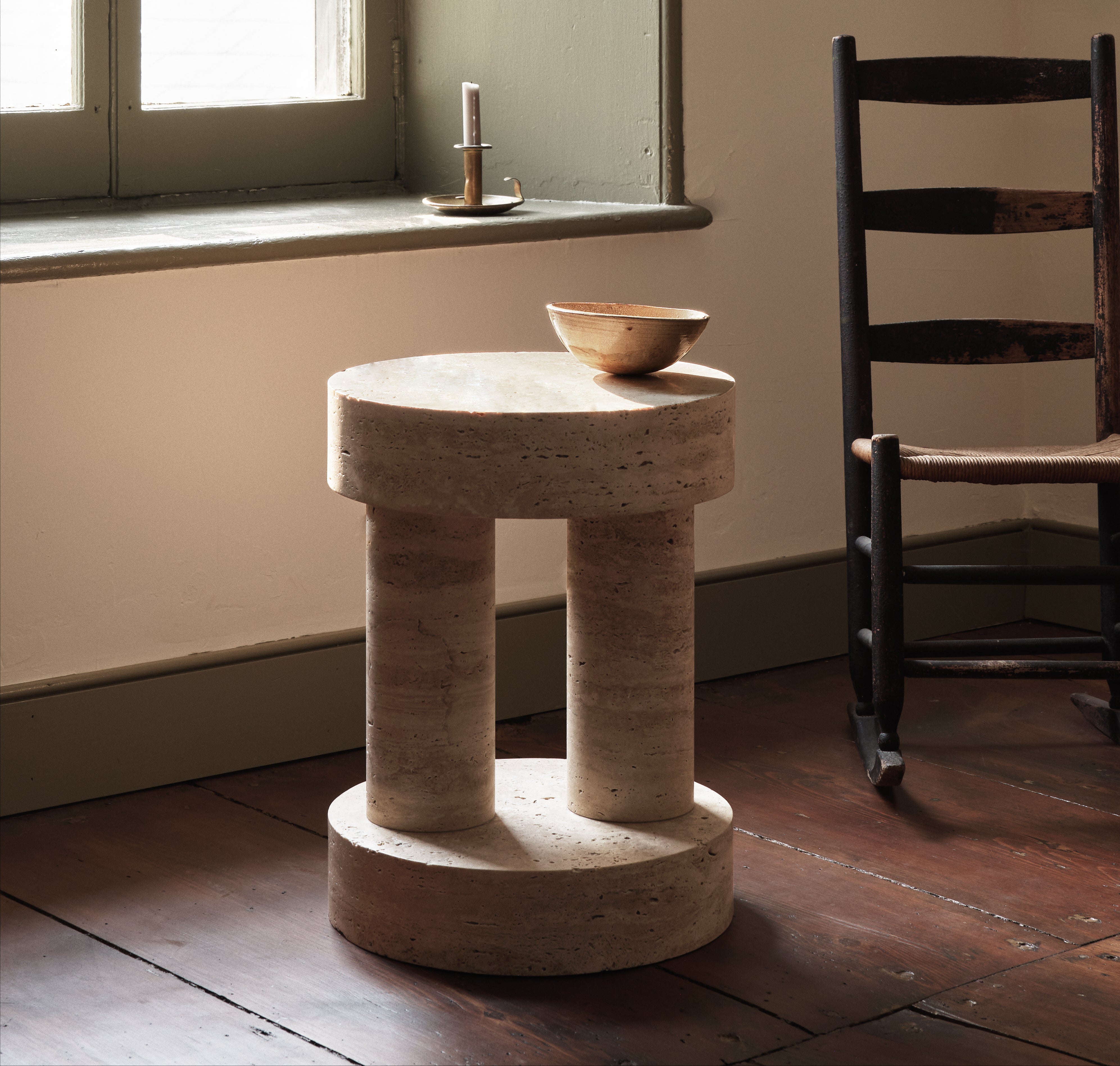 Carved from travertine or wood, these tables take their cue from carved Igbo Stools. There are four variations in the series.

Given the nature of the material, there are various shades and coloring that exist within any given block of travertine.