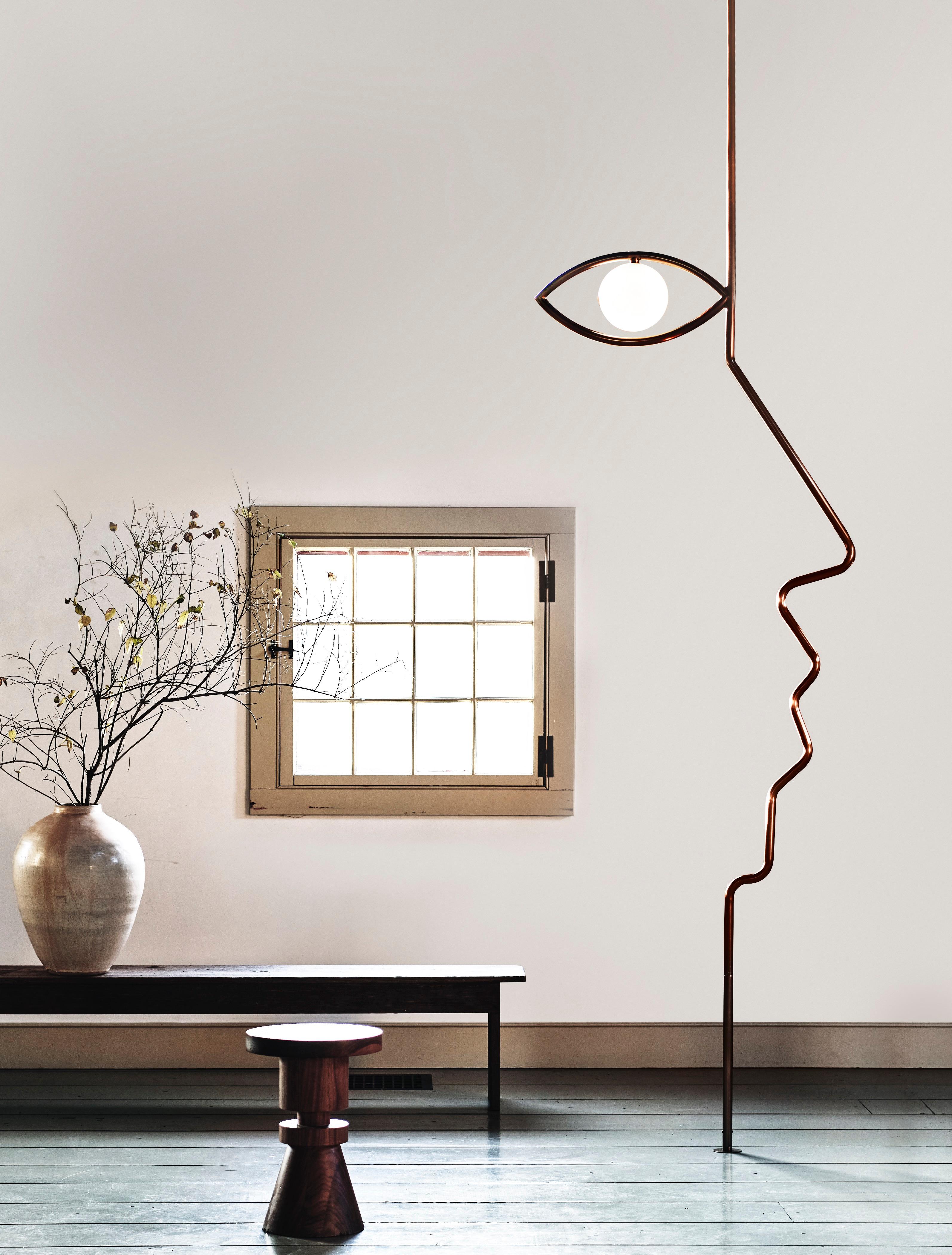 This floor-to-ceiling light sculpture traces the profile of a face in tubular steel, with a rich bronze patina. A soft glow from within the eye gives the piece life.

Materials: Brass / Glass / Steel / Aluminum

Dimensions: W – 33 5/8″, H – 81 1/8″,