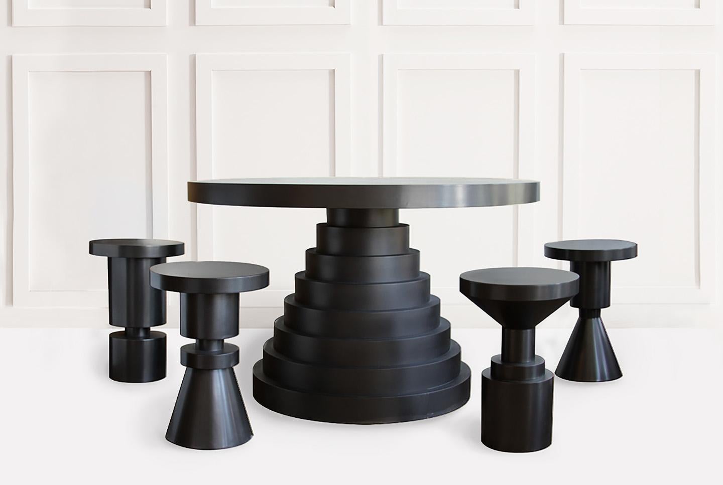 A substantial round top sits upon a layered weighted base, all finished in rich satin black. Ideal as an entry way or dining table. Available in custom sizes, as well as metal finishes. Please contact us further to discuss any custom