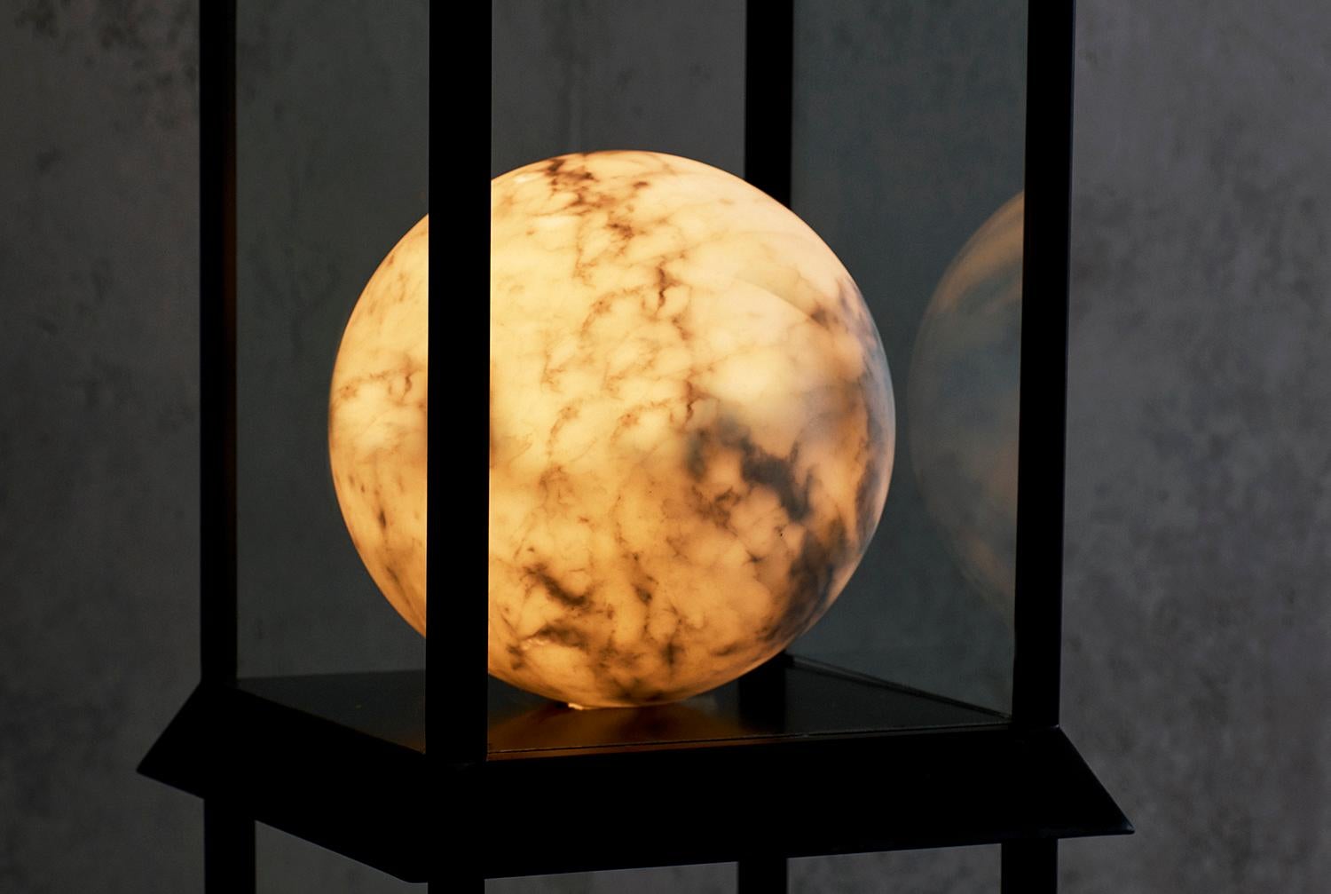 Each of these three glass vitrine cabinets contains a sphere made from a solid piece of marble which has been meticulously hollowed out from an opening only 1.5? in diameter. This extremely delicate, exacting process takes months to perform and