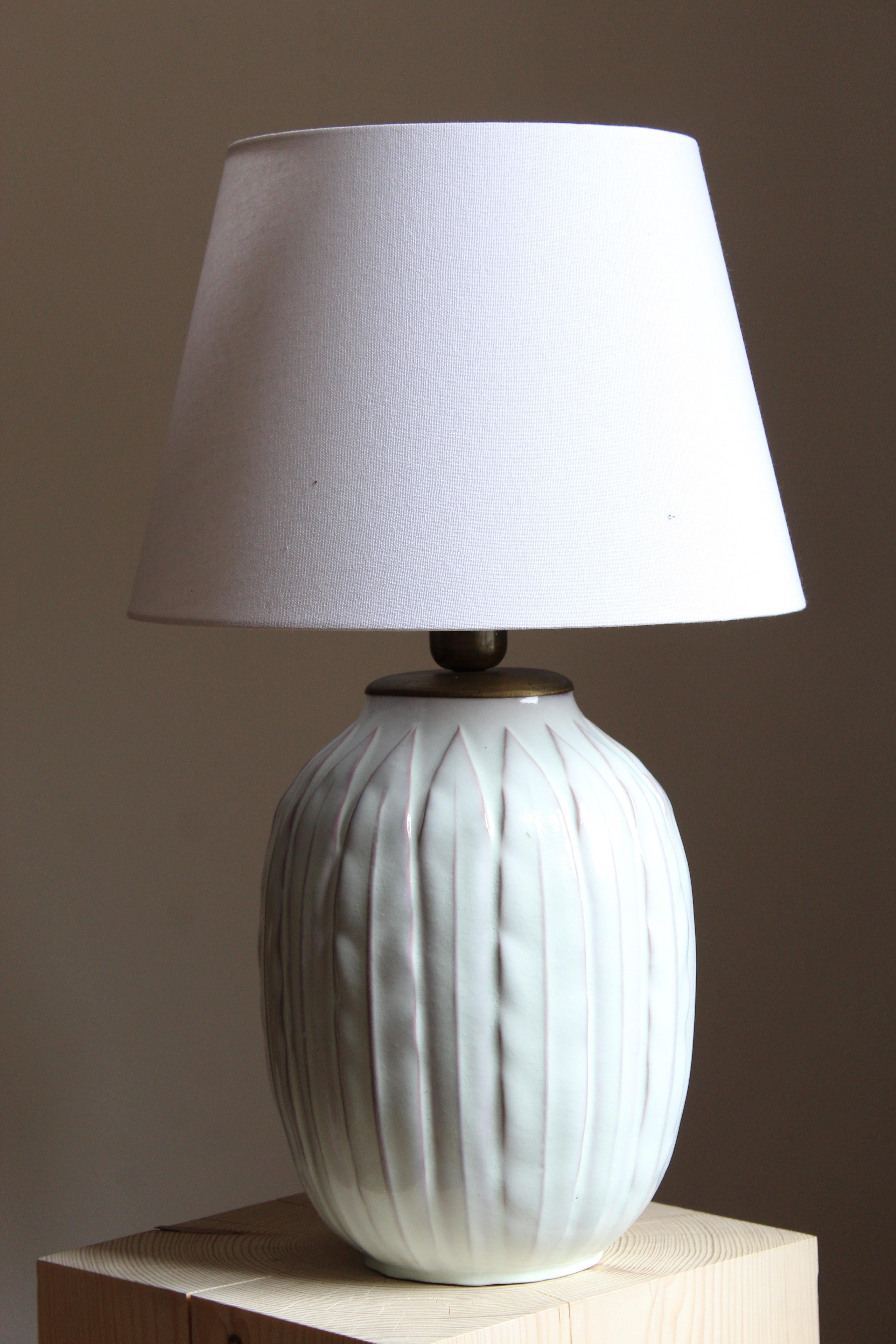 A large and early modernist table lamp. Designed by Anna-Lisa Thomson, for Upsala-Ekeby, Sweden, 1940s. With stamp including artist's initials.

Sold without lampshade. Stated dimensions exclude the lampshade.

Other designers of the period