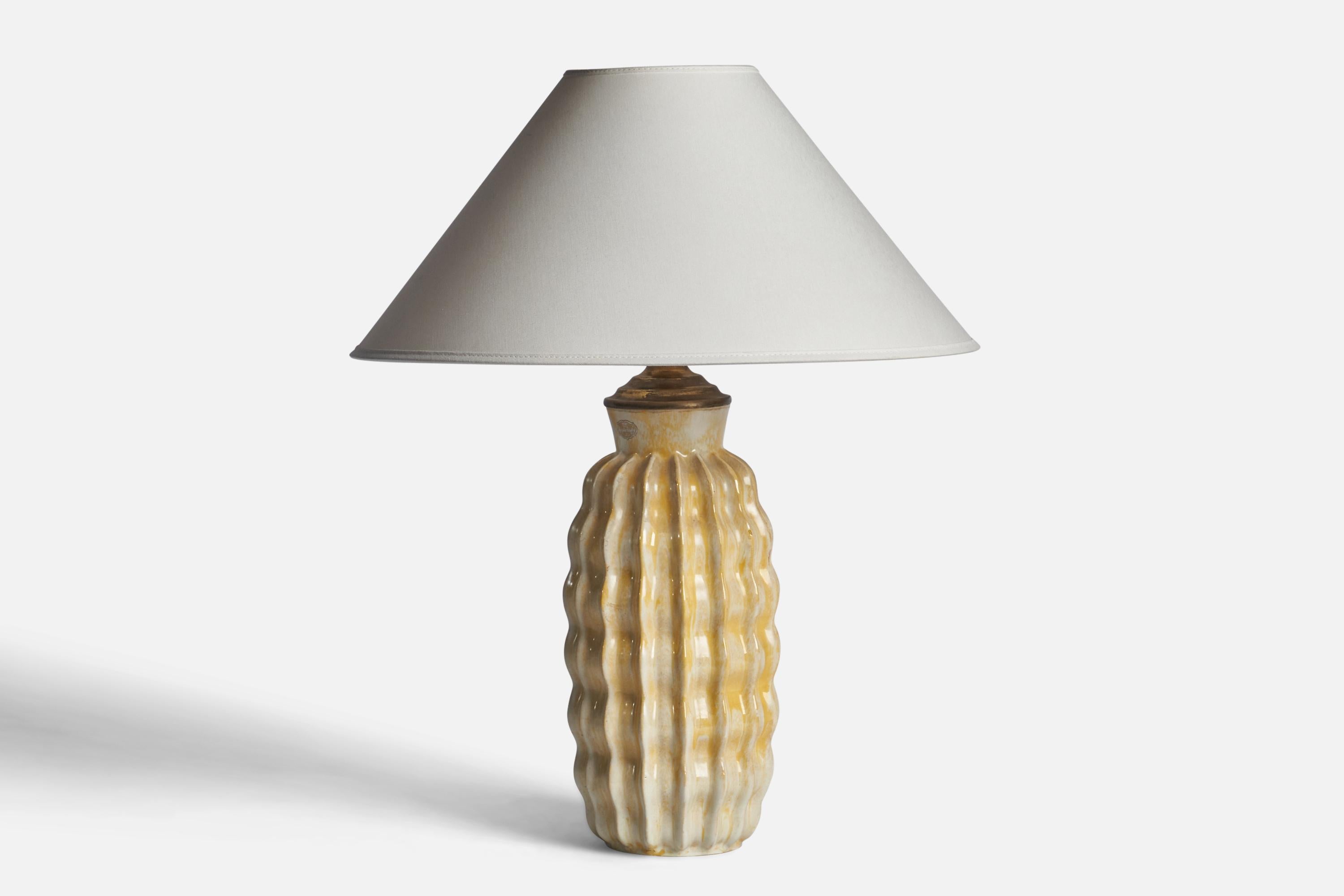 A yellow-glazed fluted table lamp designed by Anna-Lisa Thomson and produced by Upsala Ekeby, Sweden, 1930s

Dimensions of Lamp (inches): 15.65 H x 5.5” Diameter
Dimensions of Shade (inches): 4.5” Top Diameter x 16” Bottom Diameter x 7.25”