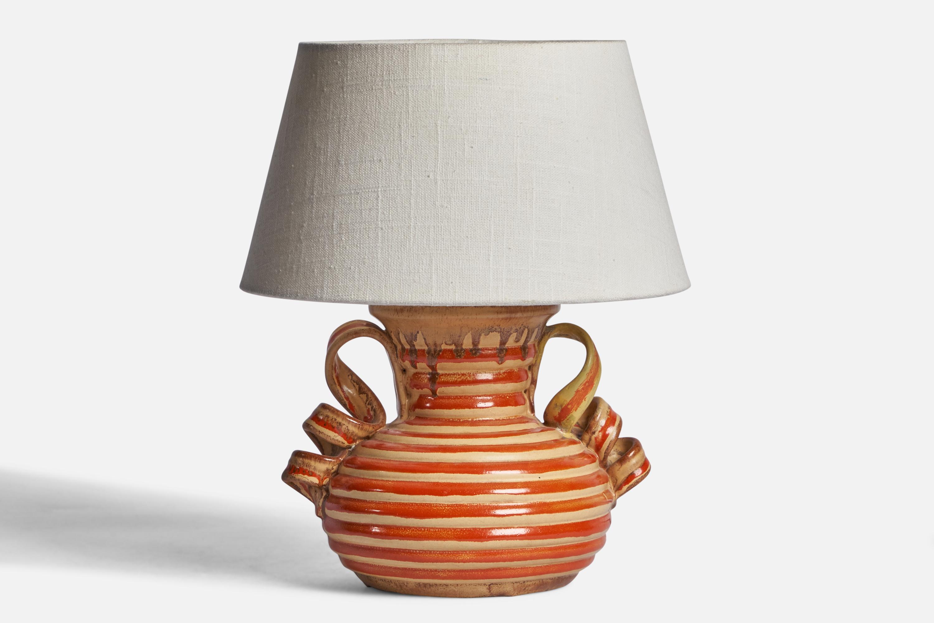 A red and beige-glazed earthenware table lamp designed by Anna-Lisa Thomson and produced by Upsala Ekeby, Sweden, 1930s.

Dimensions of Lamp (inches): 9” H x 8.25” Diameter
Dimensions of Shade (inches): 7” Top Diameter x 10” Bottom Diameter x