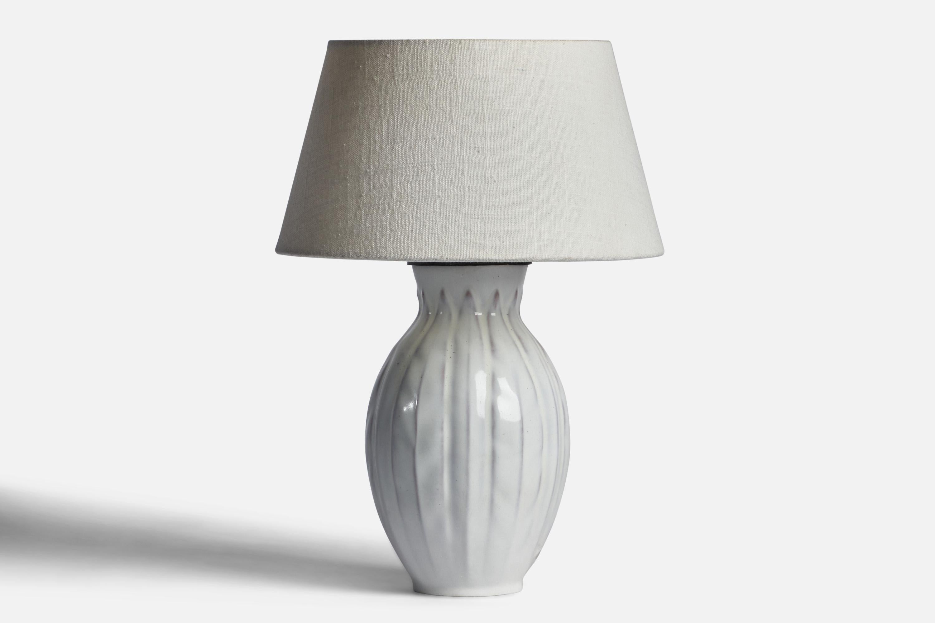 A white-glazed earthenware table lamp designed by Anna-Lisa Thomson and produced by Upsala Ekeby, Sweden, 1930s.

Dimensions of Lamp (inches): 11.15” H x 5.2” Diameter
Dimensions of Shade (inches): 7” Top Diameter x 10” Bottom Diameter x 5.5” H
