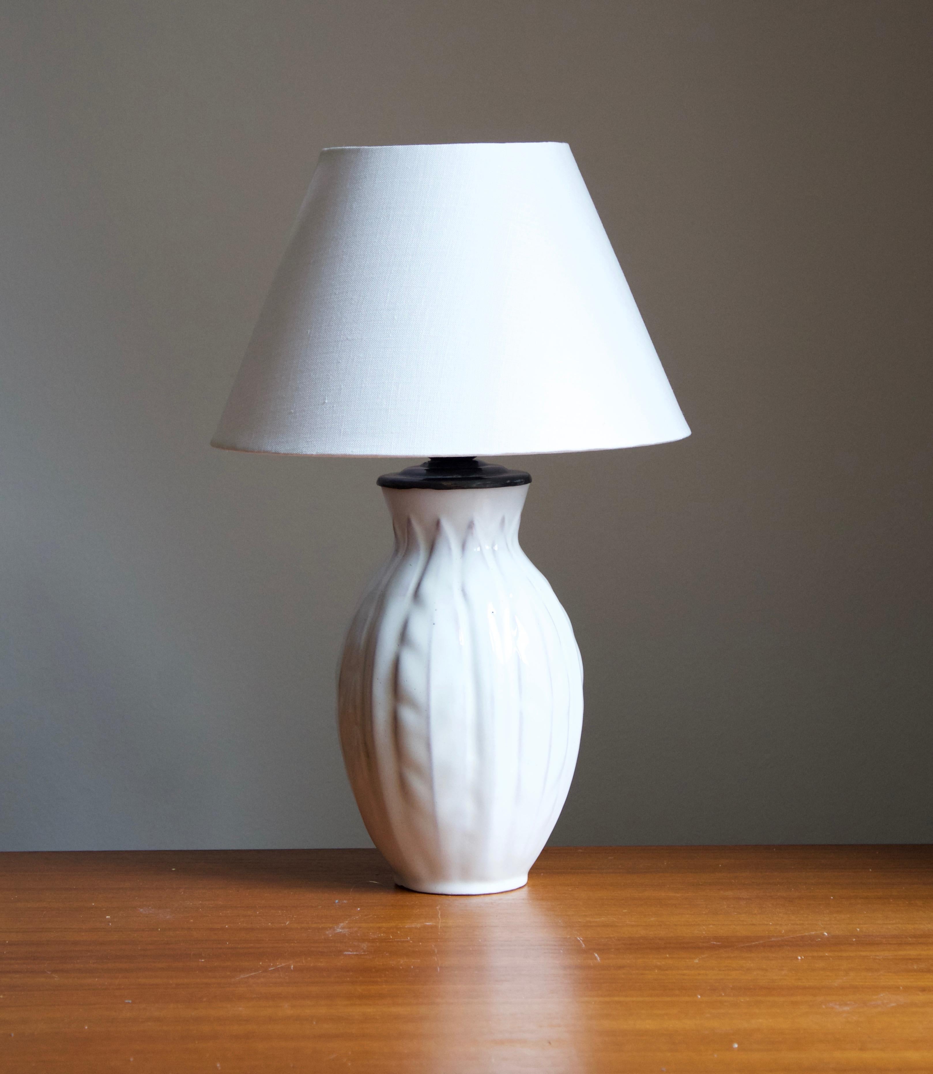 An early modernist table lamp. Designed by Anna-Lisa Thomson, for Upsala-Ekeby, Sweden, 1940s. 

Stated dimensions exclude lampshade. Height includes socket. Shade is not included in purchase.

Glaze features a white color.

Other designers of the
