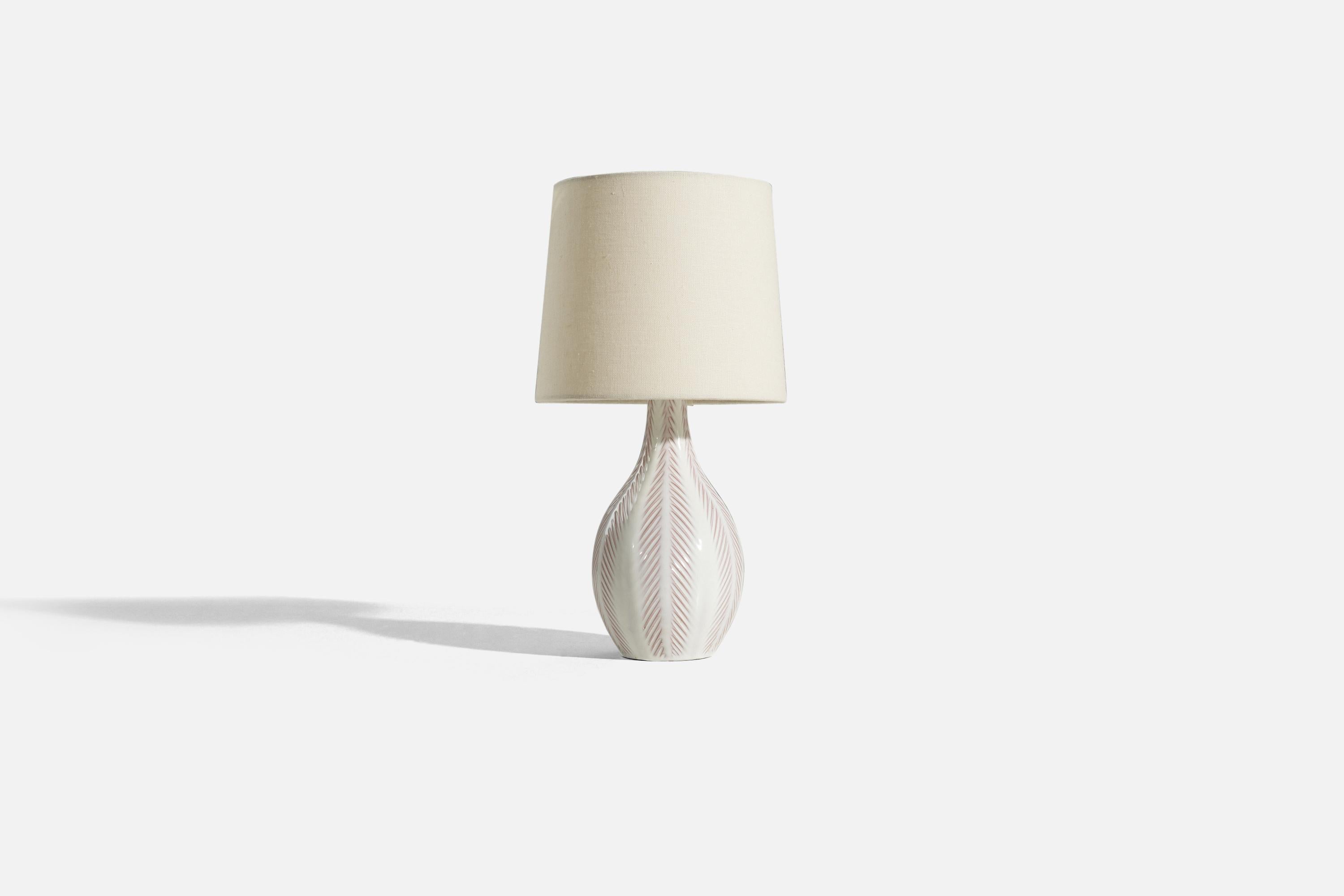 An white-glazed earthenware table lamp designed by Anna-Lisa Thomson and produced by Upsala-Ekeby, Sweden, 1940s. 

Sold without lampshade. 
Dimensions of lamp (inches) : 12 x 5 x 5 (H x W x D)
Dimensions of shade (inches) : 7 x 8 x 7 (T x B x