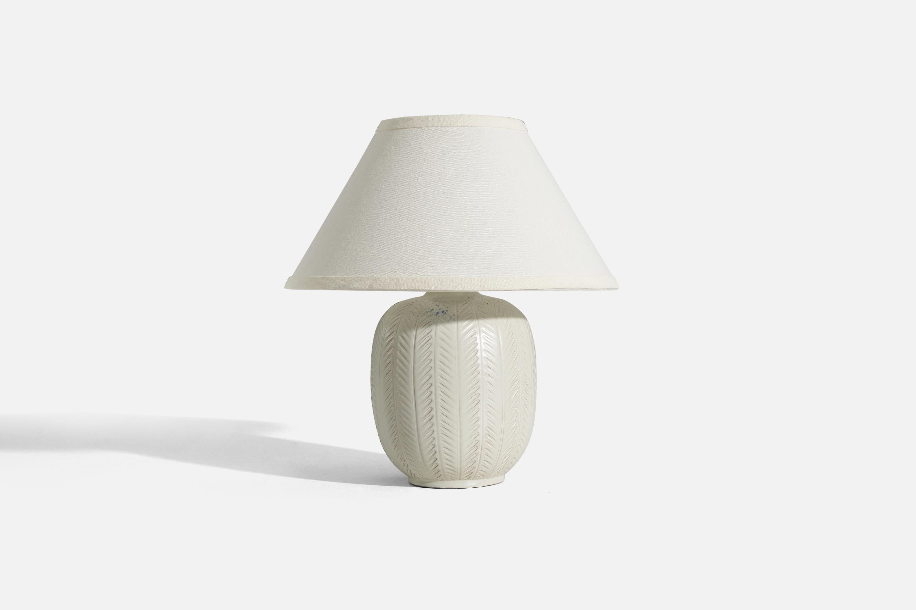 A white, glazed earthenware table lamp designed by Anna-Lisa Thomson and produced by Upsala-Ekeby, Sweden, 1940s. 

Sold without lampshade. 
Dimensions of Lamp (inches) : 10.375 x 6.125 x 6.125 (H x W x D)
Dimensions of Shade (inches) : 5.25 x